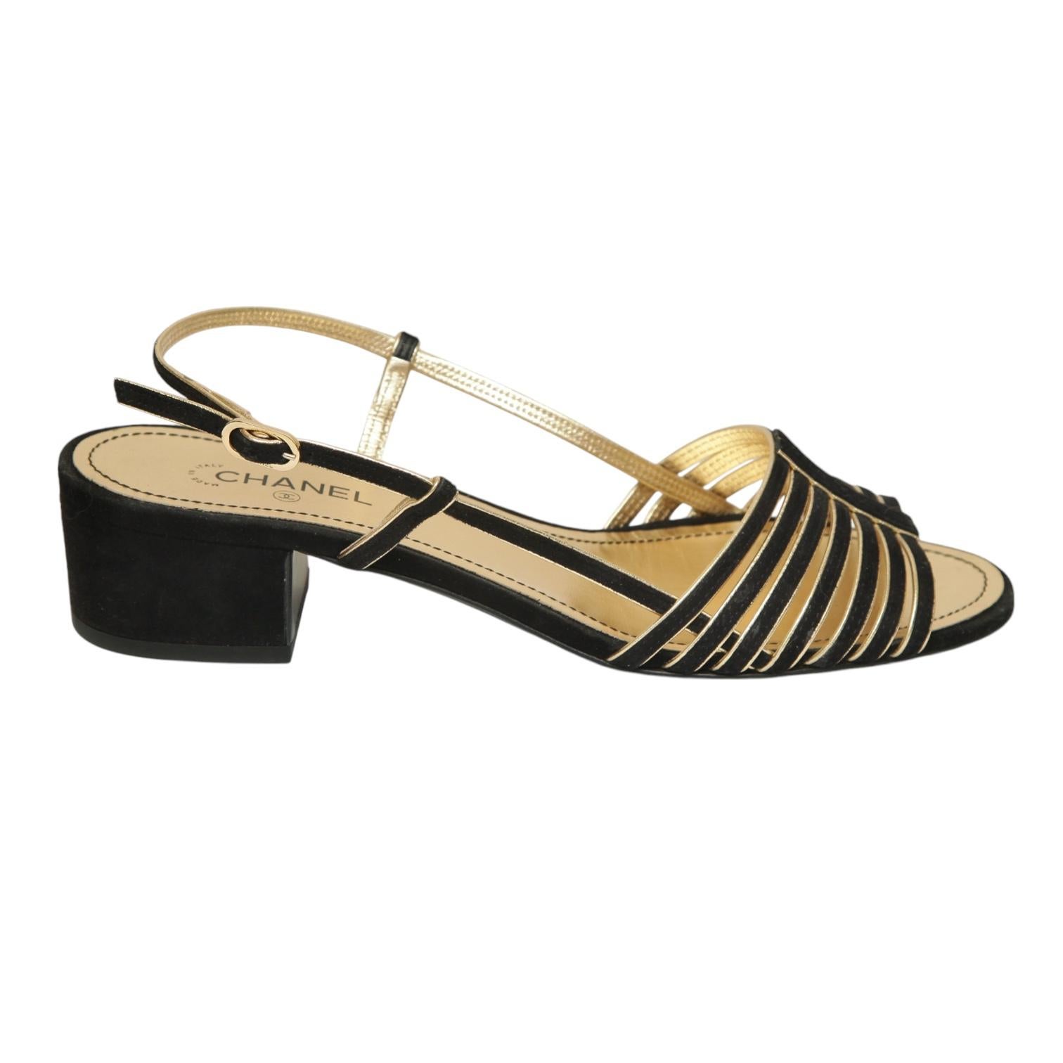 GUARANTEED AUTHENTIC 2021 COLLECTION CHANEL BLACK SUEDE/GOLD LEATHER SANDALS

Design:
- Black suede and gold leather trim uppers.
- Thin straps over top of foot.
- Slingback, buckle closure.
- Leather insole and sole.
- Comes with dust bag.

Size: