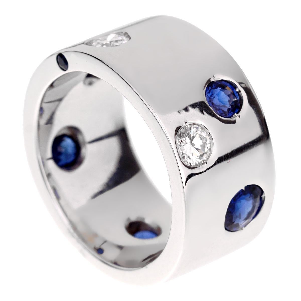 A fabulous Chanel band style ring showcasing 2 round brilliant cut diamonds and 6 sapphires set in 18k white gold. The ring measures a size 6 1/4

Width: .39