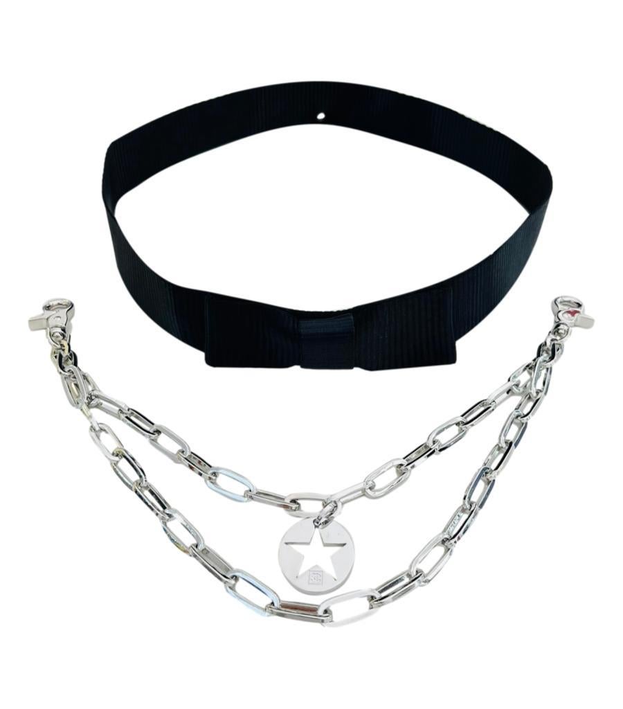 Chanel Satin Bow Belt With Star 'CC' Logo Chains

Black belt with bow to the centre, designed with detachable chain.

Featuring round star cut-out charm with signature 'CC' logo.

Styled with snap closure and branding to the silver hardware.

From