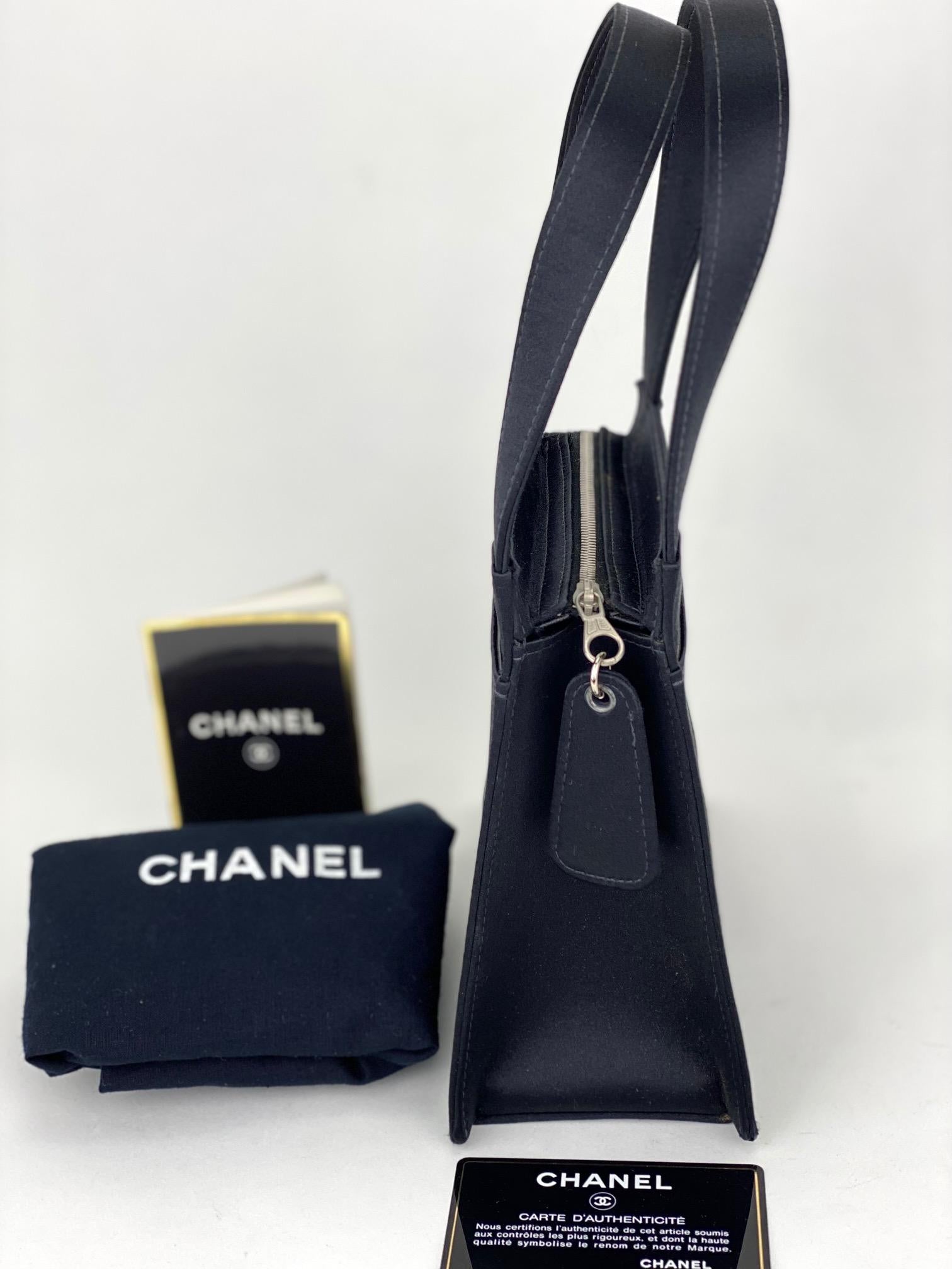 Pre-Owned  100% Authentic
Chanel Satin Vintage Black Handbag
This mini size tote can hold a max cell
phone and other essentials. It just makes
the perfect evening bag with its Satin Material
RATING: B    very good, well maintained,
shows minor signs