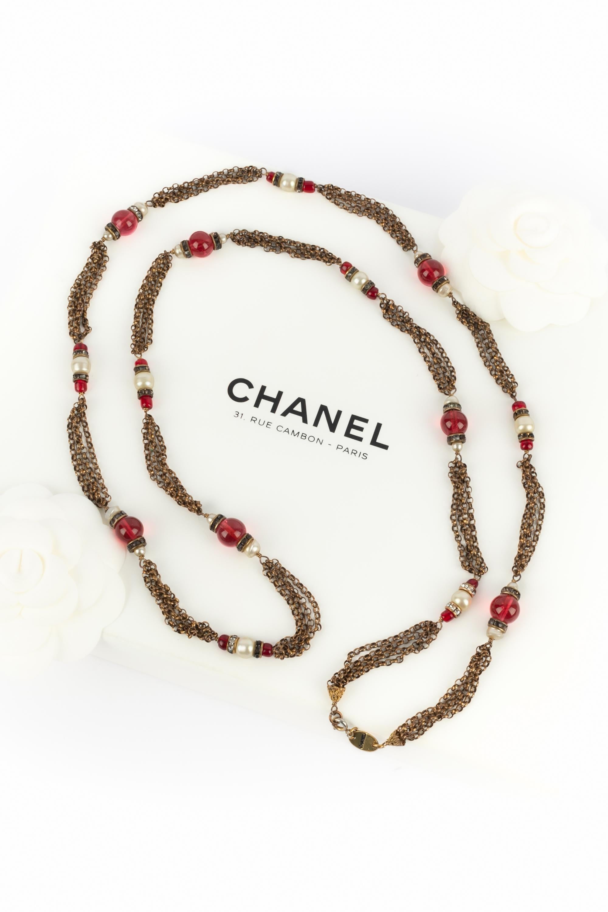 CHANEL - (Made in France) Long antique-golden metal necklace with costume pearls and red glass pearls. Jewelry from the 1950s-1960s.

Condition:
Very good condition

Dimensions:
Length: 110 cm

SKU:CB161