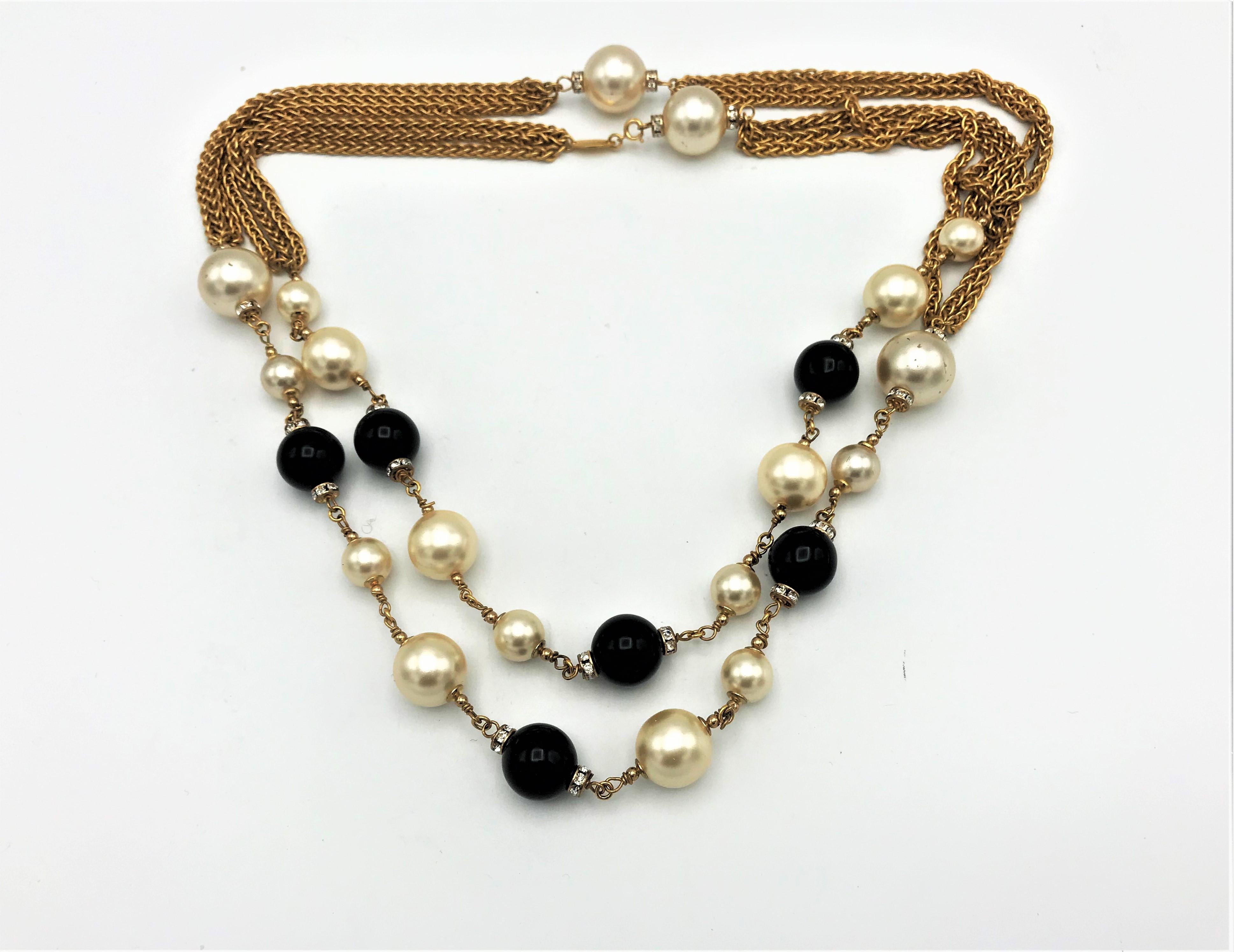 Very rare Chanel necklace/Sautoir with black Gripoix glass balls from the house of Gripoix Paris and imitation pearls, these are still provided with rhinestone rondels. 
Dimensions: length of the Sautoir 128 cm, pearls in the size from 1.6 cm to 0.7
