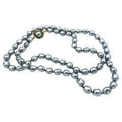 CHANEL SAUTOIR,  silver-grey baroque pearls, signed 1981, 92 cm long.