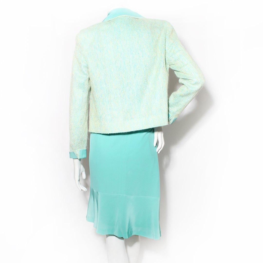 Three-piece suit by Chanel
2001 collection 
Includes jacket, tank, and skirt in teal 
Multicolor knit jacket 
Two front pockets 
Open front 
Slight shoulder pad 
Cuffed sleeves 
Crop tank top 
Keyhole back 
Button neck closure 
High waist skirt