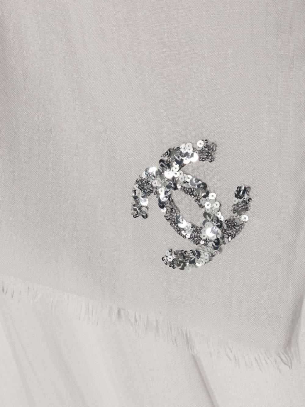 This authentic Chanel scarf features delicate hand-rolling and stitching, ensuring a high-quality and luxurious finish. The signature interlocking CC logo at the front corner adds a touch of elegance to any outfit, making it a must-have accessory