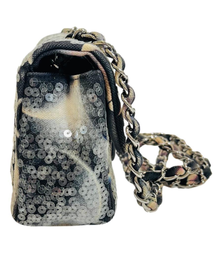 Rare Item - Chanel Sequin Moon Mini Flap Bag

Black bag styled with unique 'Moon' designs and fully covered with transparent sequins.

Detailed with Chanel's signature silver 'CC' twist lock closure and fabric and chain entwined shoulder