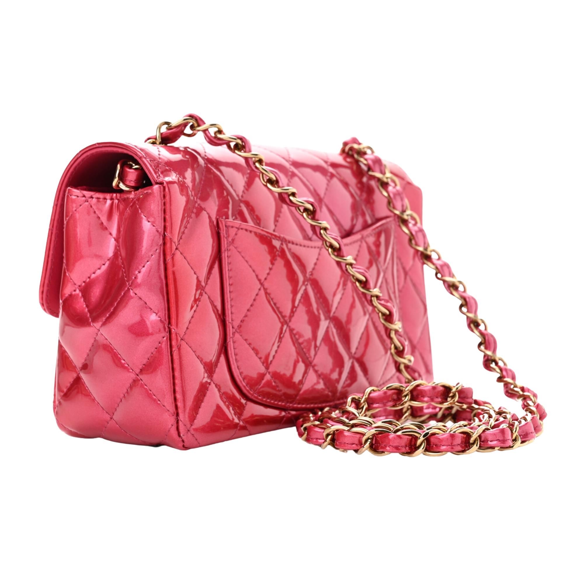 This bag is made out of luxurious diamond quilted iridescent patent leather in gradient pink. The bag features a crossbody leather threaded gold chain link shoulder strap, a frontal flap, and a gold Chanel CC turn lock. This opens to a pink interior