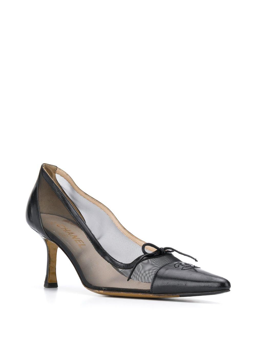 Crafted in France from smooth black leather, these pre-owned pumps by Chanel are for the fashion forward, featuring a distinctive sheer mesh panel design, an easy slip-on style and a mid-high stiletto heel. For an added touch of sophistication,