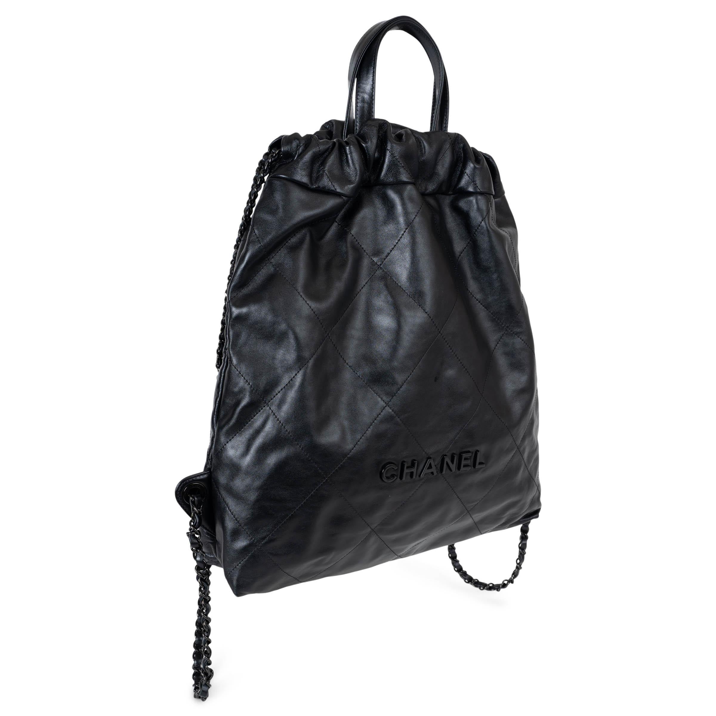 This 100% authentic Chanel 22 Large So Black backpack in black shiny calfskin leather embodies modern elegance with a monochromatic edge. Featuring black hardware, two black leather top handles, and signature black metal chain straps, it seamlessly