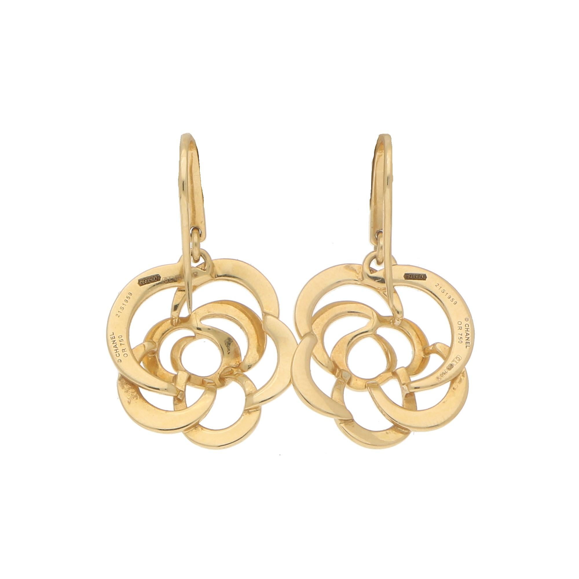 A rather interesting pair of signed Chanel Camellia dangly earrings set in 18k yellow gold. Each earring depicts an openwork gold flower which hangs delicately on a hoop fitting so that the flowers can move on the ear.

The polished yellow gold