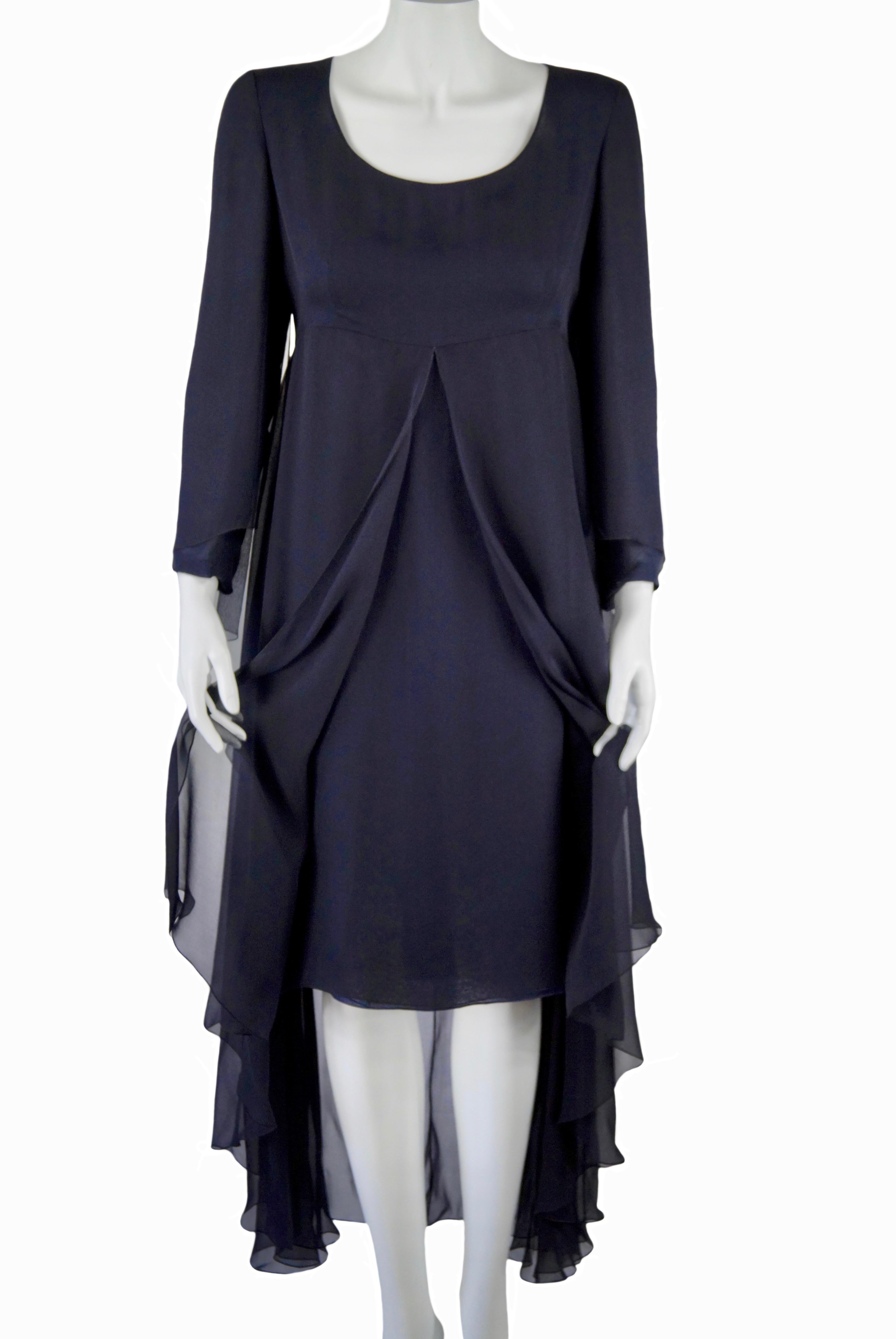 CHANEL Cruise Collection 2002
Multi-layered midnight blue silk voile cocktail dress. 
Empire style décolleté with large layered drapery, asymmetrical, long sleeves with free flounces. Back zip.
Size FR 40
Made in France
100% silk
100% silk