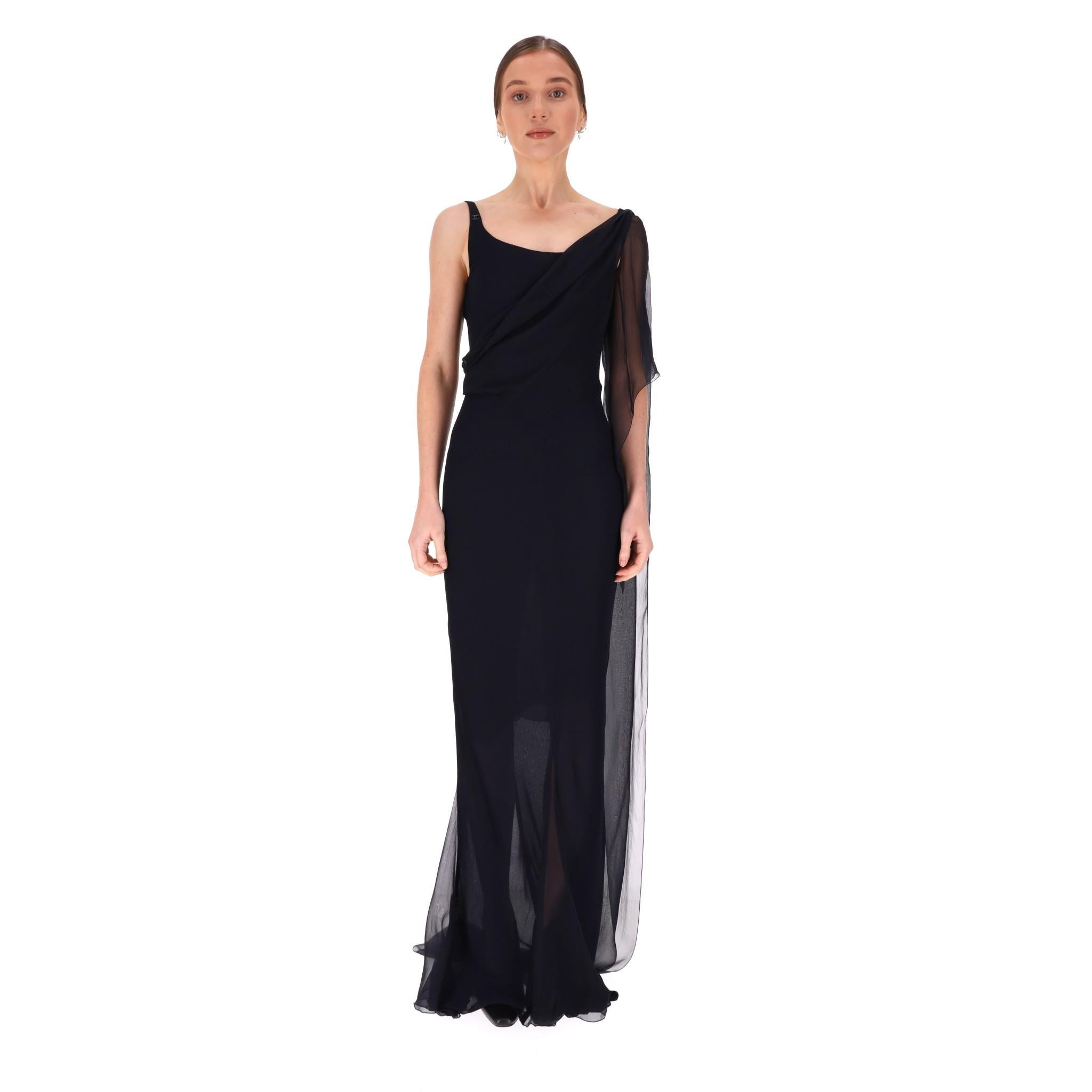 Chanel Silk Chiffon Draped Evening Gown

From Cruise 2002 Collection is this evening gown crafted in midnight blue silk.

Embellished with drape panels of silk chiffon falling over the arm and iconic 'CC' logo detail to the other side.

Fitted