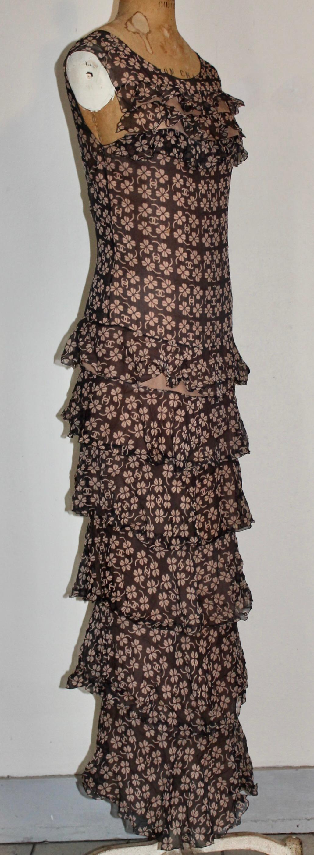 Based on the classic Coco Chanel Tiered Cocktail Dress,
Karl Lagerfeld's homage is printed with a transparent black repeated floral  and CC logo pattern. EU appx size
36-38.
