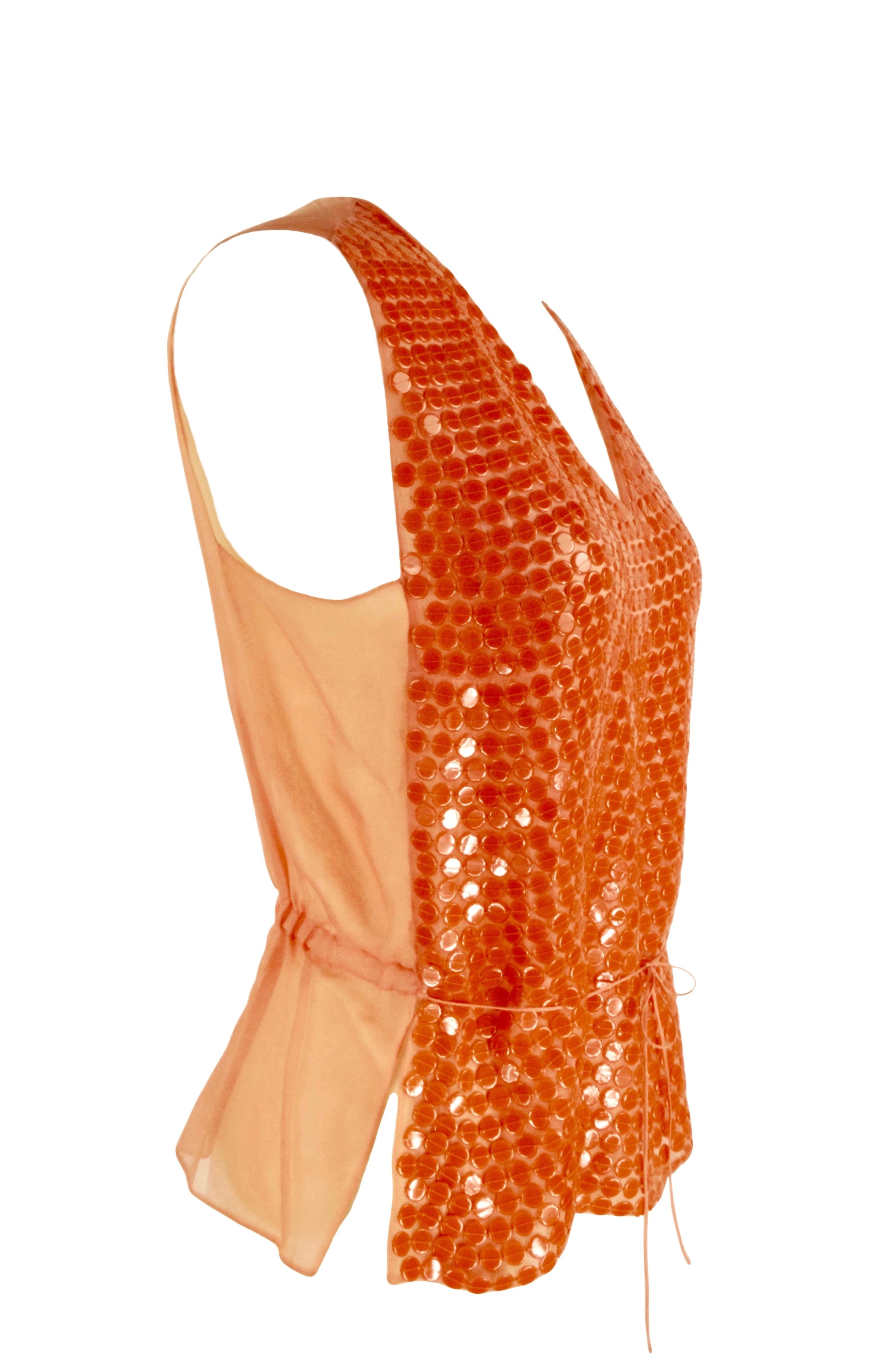 CHANEL Cruise 2000
Silk orange top
On the front giant sequins , on the back organza silk, thin silk belt
Size FR 42
Made in France
100% silk
Flat measures:
Length  cm. 56
Shoulders cm. 35
Bust cm. 46
Waist line cm. 39
