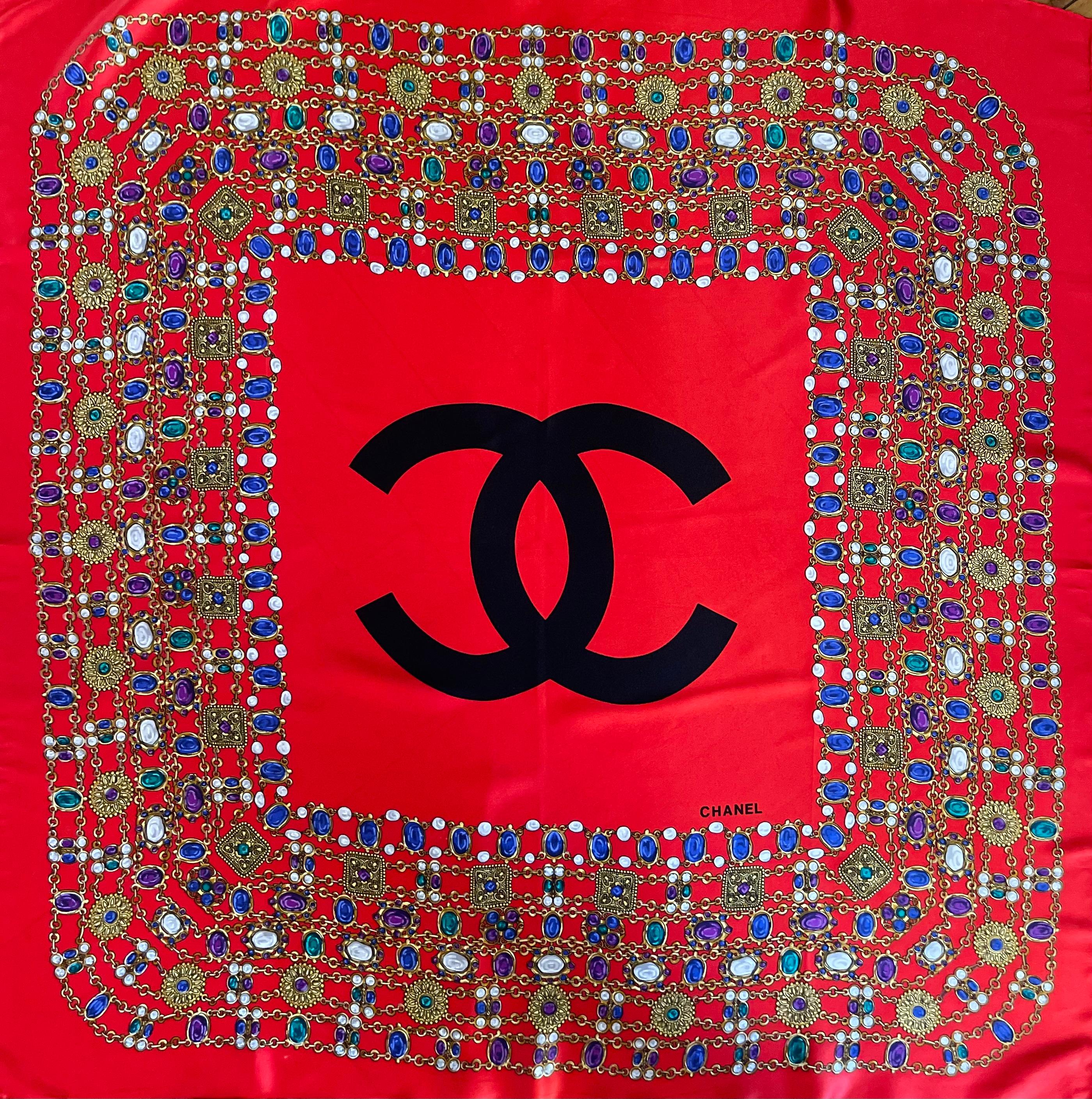 Chanel Silk Scarf Red Gripoix. This beautiful scarf is in great condition. The gripoix is a perfect statement of the brands classiness and creativity. The color is bold, vibrant and easy to wear during spring and summer. The center logo adds a touch