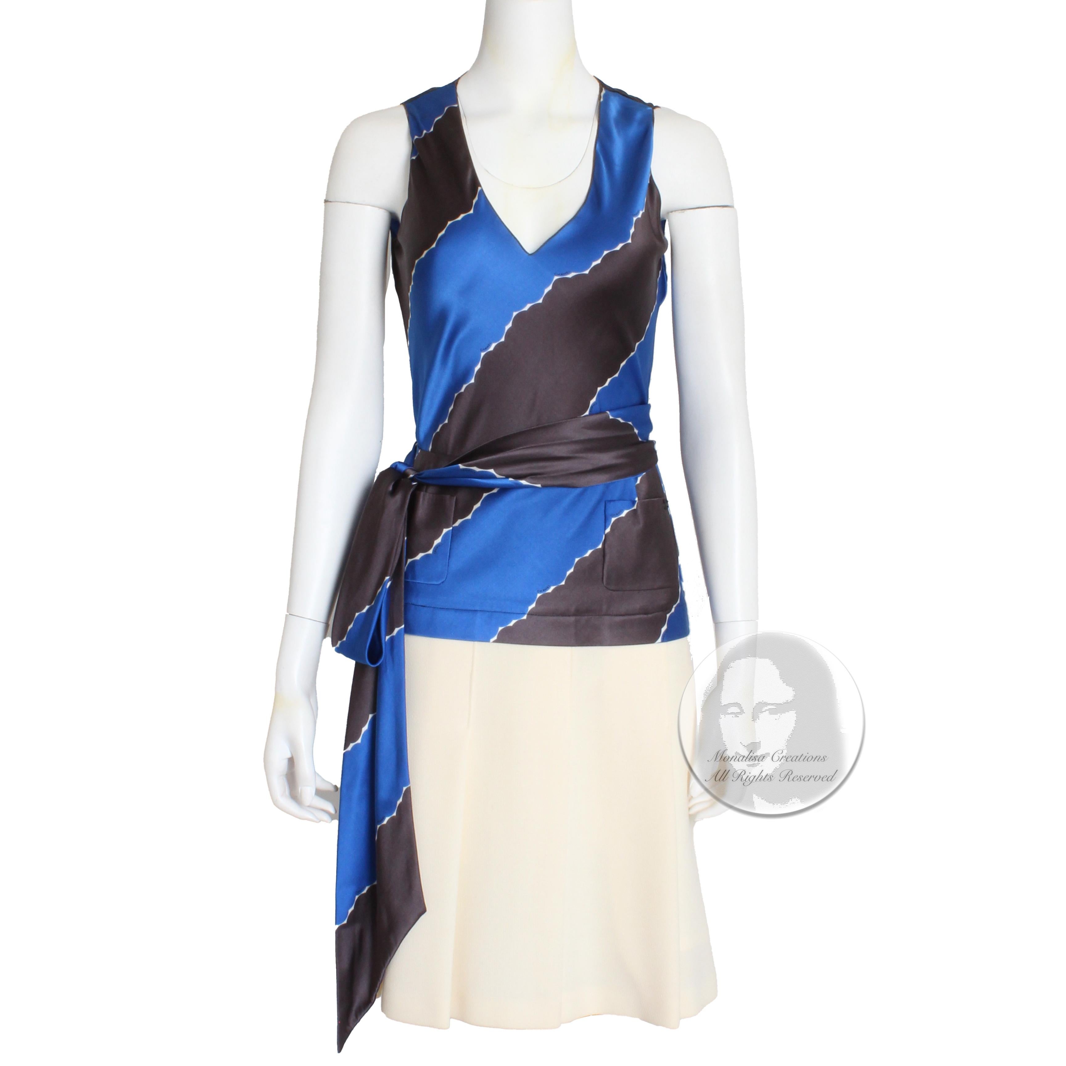 Authentic, preowned Chanel sleeveless top with matching pleated skirt, from the '05C collection.  Made from an abstract print in blue and pebble brown, the top features a v-cut collar and slips over the head.  The skirt is made from matching silk at