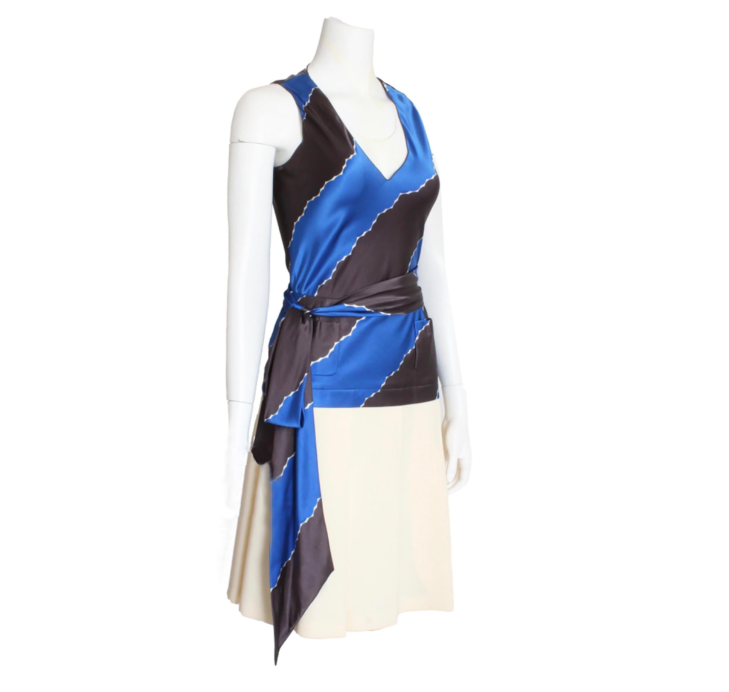 Authentic, preowned Chanel sleeveless top with matching pleated skirt, from the '05C collection.  Made from an abstract print in blue and pebble brown, the top features a v-cut collar and slips over the head.  The skirt is made from matching silk at