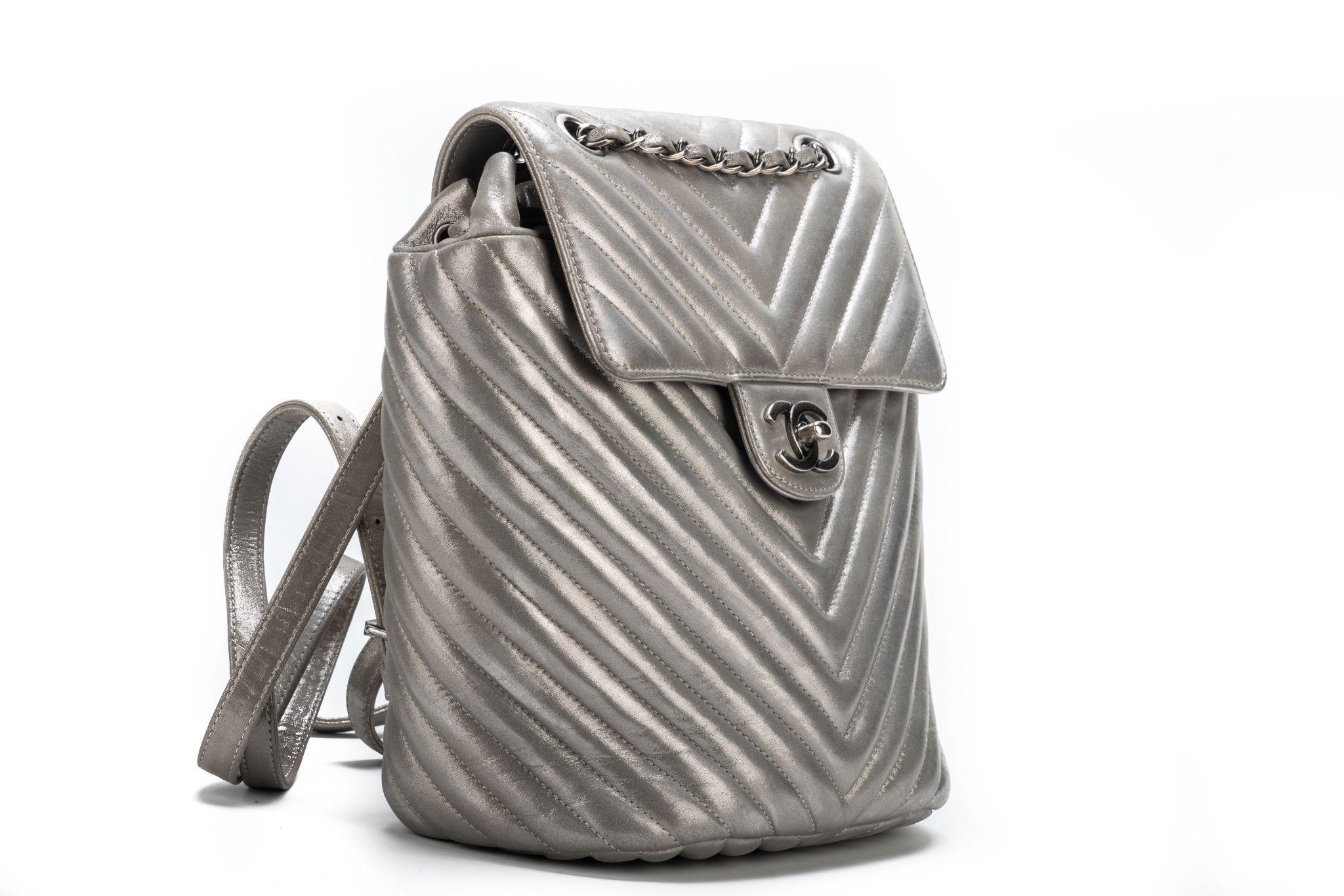 Chanel mint condition silver lambskin chevron backpack. Handle drop 4”, adjustable straps. Comes with hologram, card and original dust cover. Collection 22.

