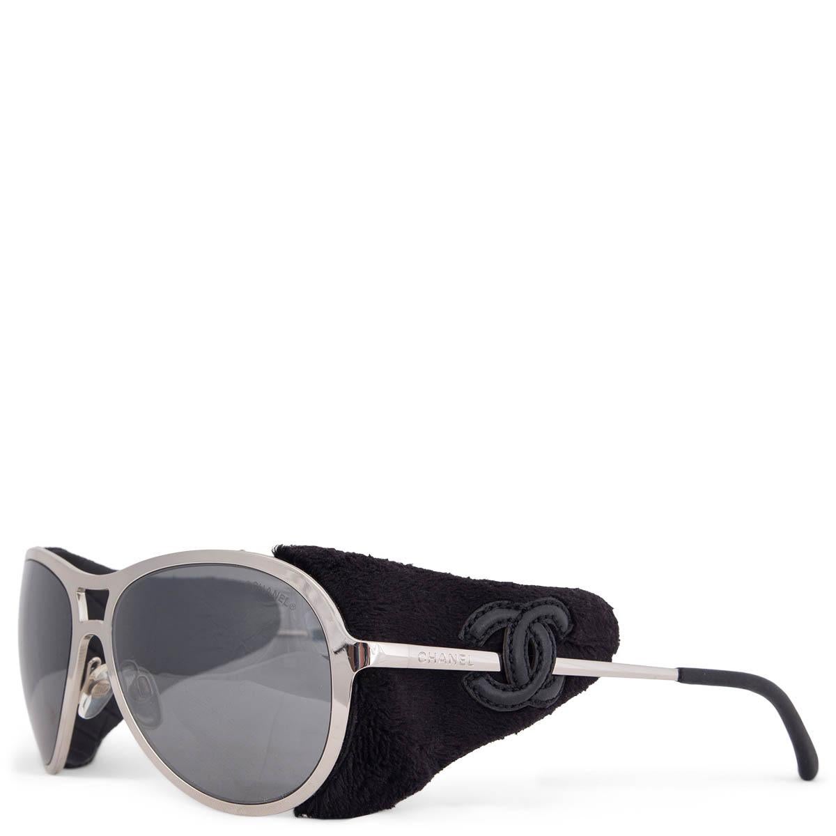 100% authentic Chanel Coco Neige side-shield Sunglasses made of silver-tone metal and black leather shields on the side with mirrored lenses. Have been worn and are in excellent condition. Come with case. 

Model	40852 L441 3N
Width	14.5cm