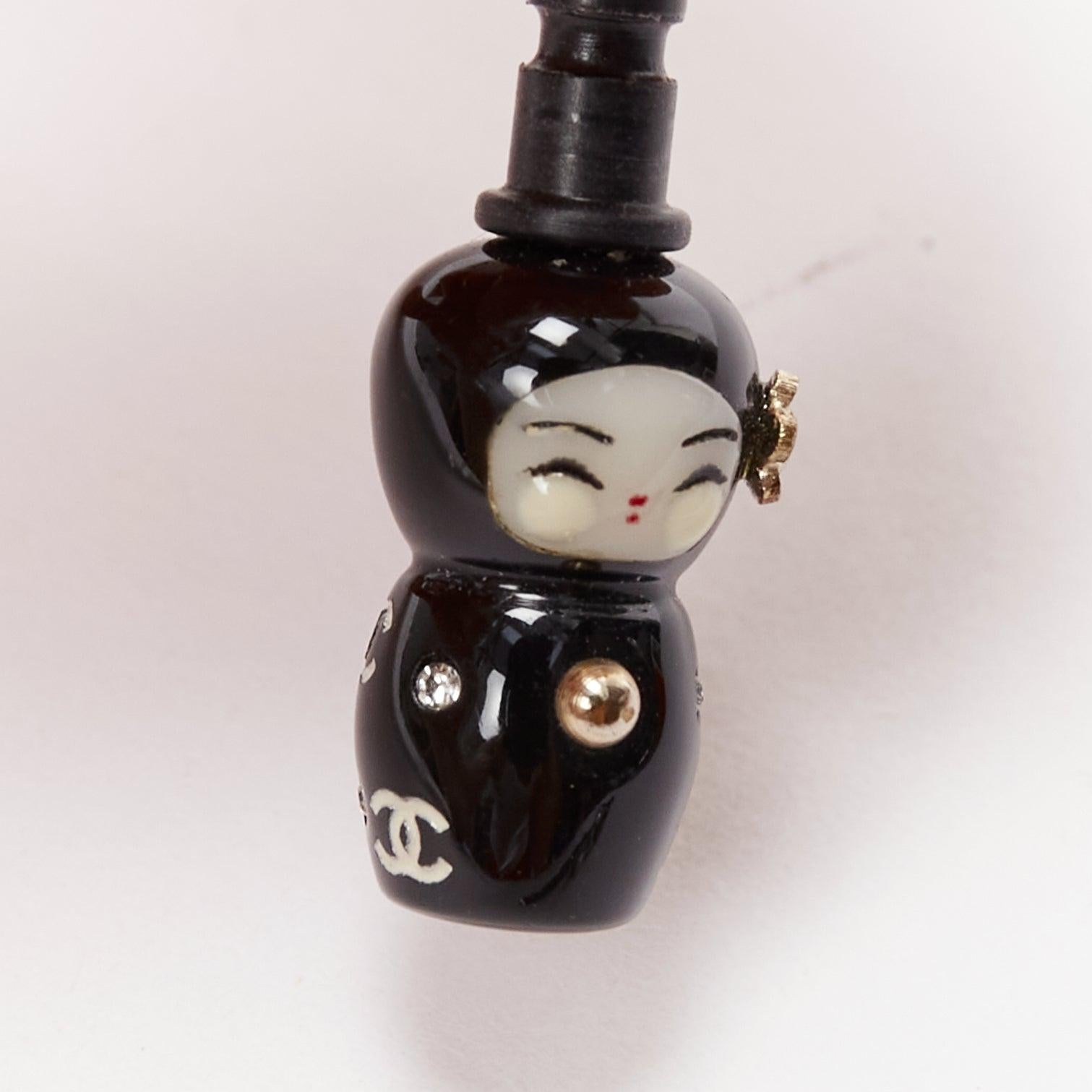 CHANEL silver crystal CC black china doll earphone jack charm x2
Reference: AAWC/A00892
Brand: Chanel
Designer: Karl Lagerfeld
Material: Plastic
Color: Silver, Black
Pattern: Solid
Extra Details: Silver crystal embellished CC plug. Black china doll