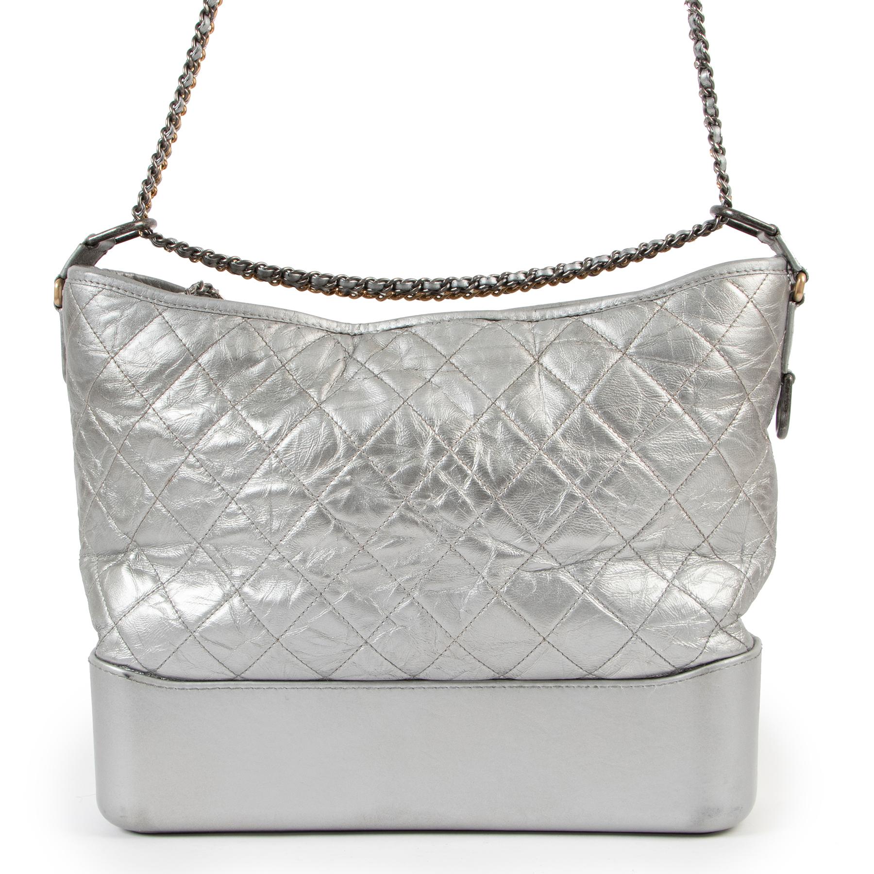Latest IT bag from Karl Lagerfeld's creation. This silver iteration translated the Gabrielle hobo bag into a statement piece. Features a sturdy base that provides structure for the quilted leather upper, the bag comes with a unique chain strap