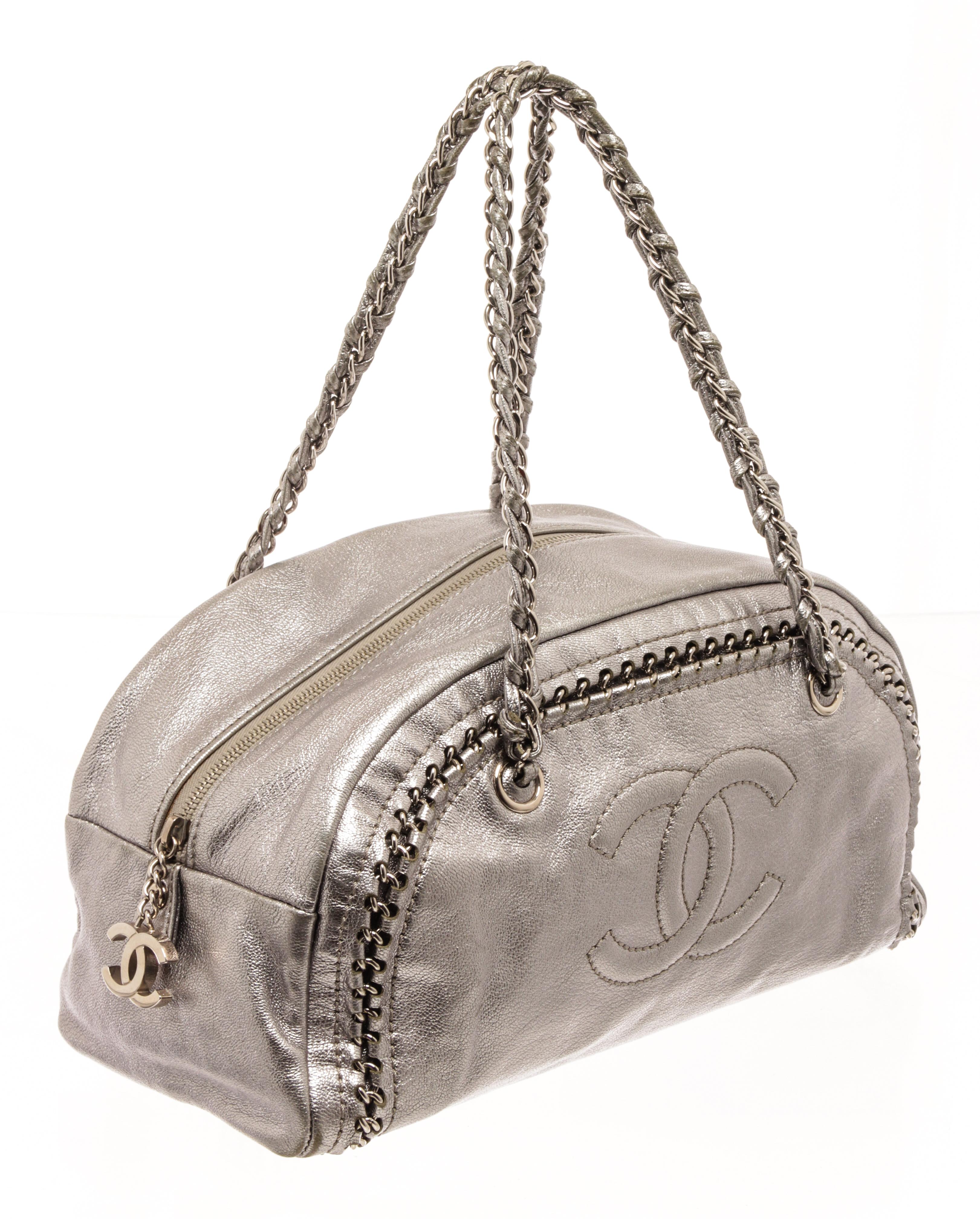 Chanel Silver Leather Doctor Shoulder Bag with silver grained leather exterior, silver chain strap, leather lining, interior pocket, zipper closure. There are some markings on the lining as shown in photos. 

87505MSC