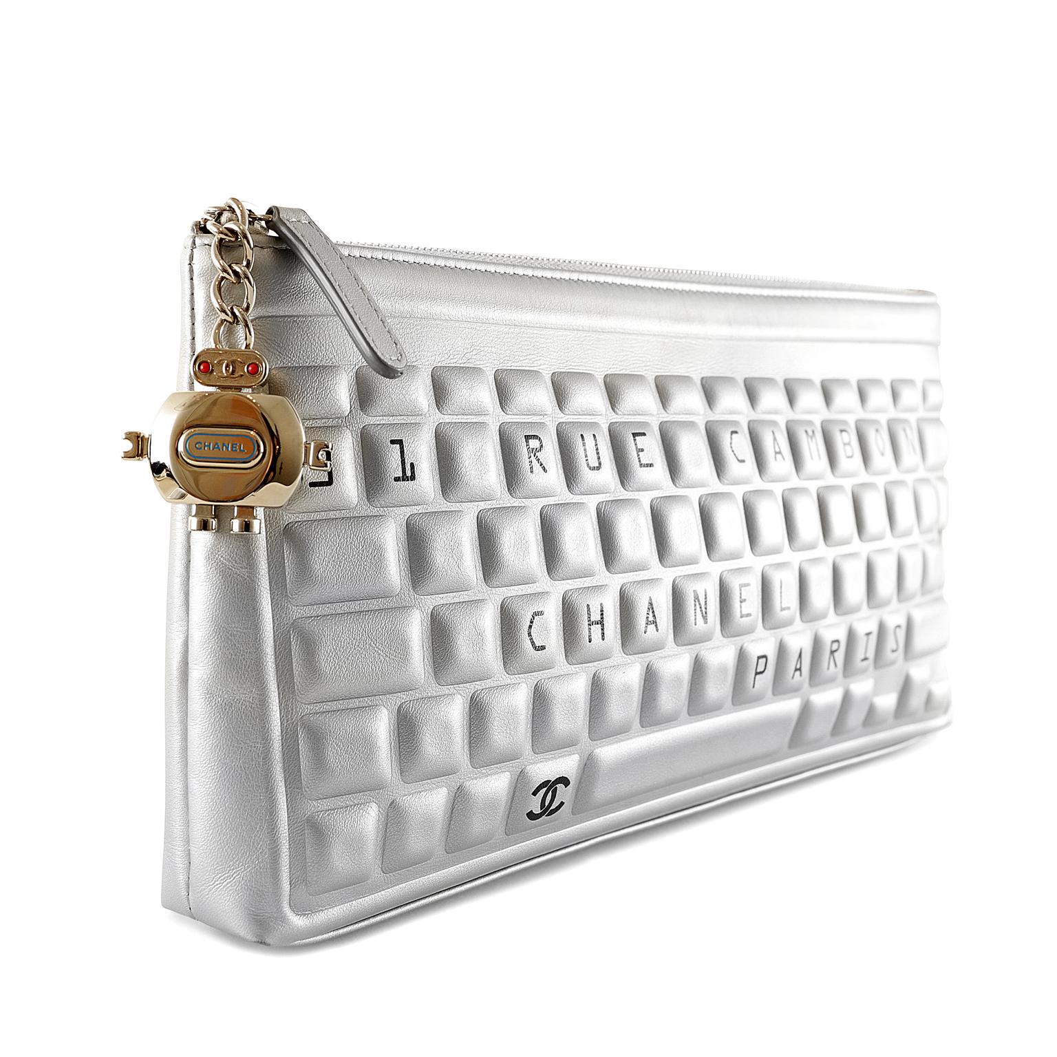 Chanel Silver Leather Keyboard Clutch- Pristine
From the 2017 Data Center collection, this whimsical clutch is a must have.  
Muted metallic silver leather clutch is quilted in a keyboard pattern with “31 RUE CAMBON” and “CHANEL PARIS” lettering.