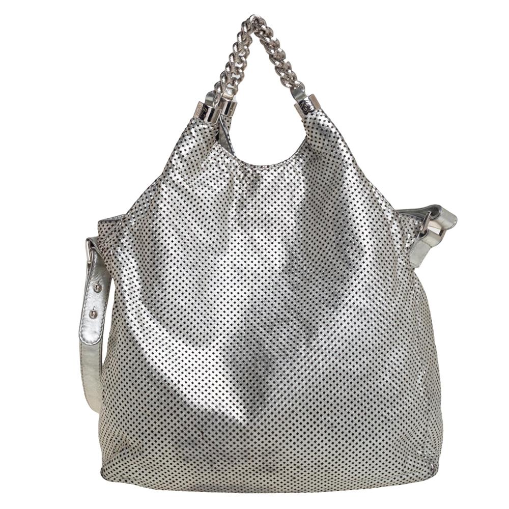 Rock-chic and yet so elegant! This Chanel bag is ideal for the modern woman who commutes daily and travels often. Crafted from silver leather, the creation is designed with perforated details all over and is equipped with a spacious interior for
