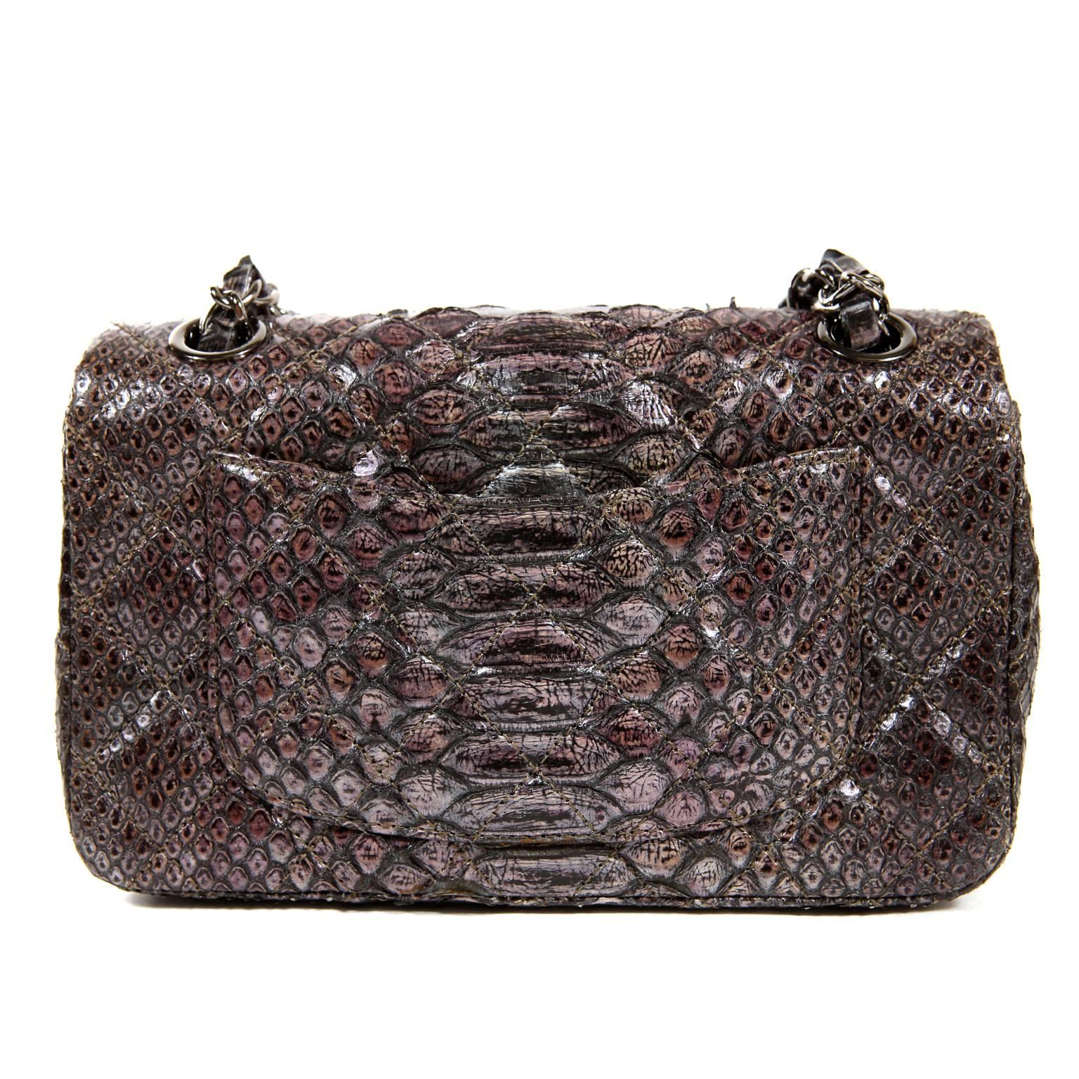 Chanel Python Small Flap Bag is exquisite.  Pristine and never carried, this exotic Chanel is a brilliant addition to any collection.
Silver and lilac hued python skin is subtly quilted in signature Chanel diamond pattern.  Oversized gold crystal