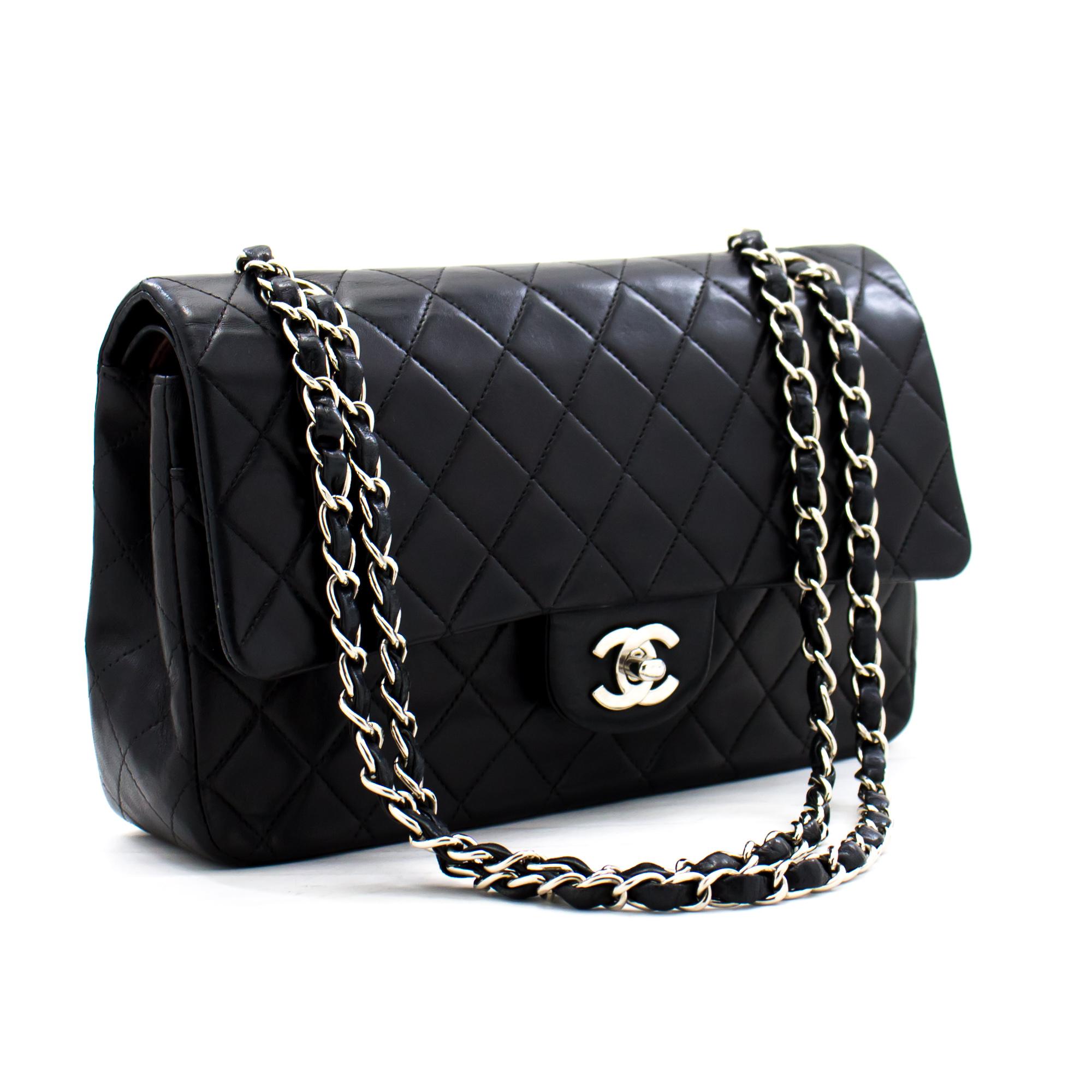 This iconic Chanel 10 inch bag is crafted from quilted black lambskin and features a double flap. On the front flap there is the classic CC logo twist lock, and on the second flap a stud closure with one slip-in pocket. The inside lining is covered