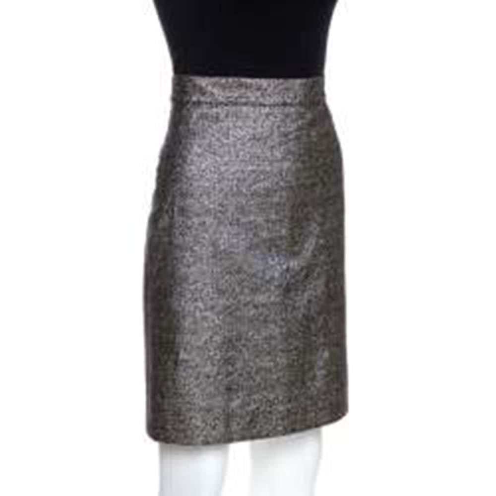 This skirt from the house of Chanel is of a kind that you would love to wear forever. It is made of blended fabric in with short hem flaunting a metallic silver hue. This fashionable piece has a shimmery finish and a zip closure at the rear for