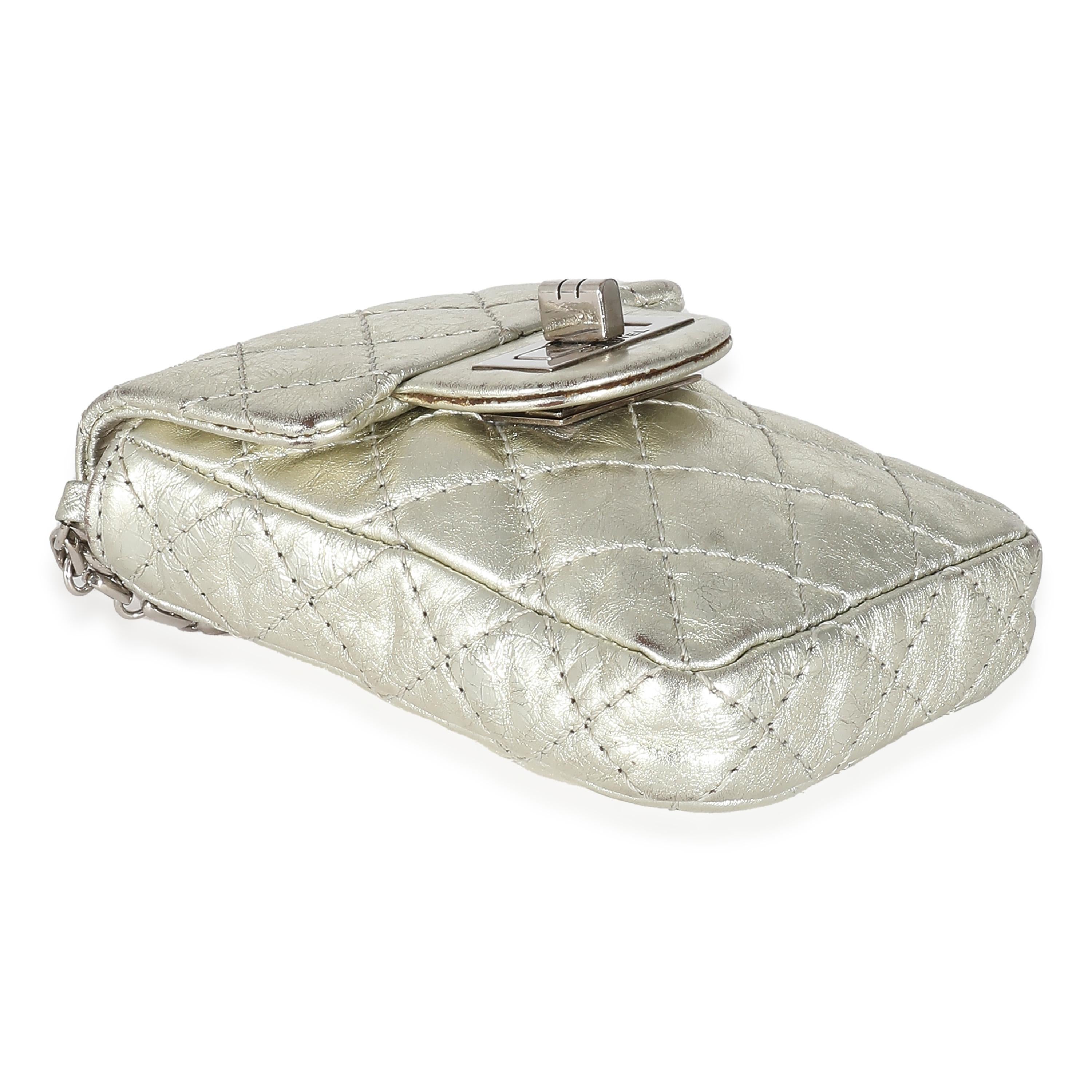 Listing Title: Chanel Silver Metallic Aged Calfskin Quilted 2.55 Reissue Phone Case
SKU: 133989
Condition: Pre-owned 
Condition Description: In 2005, Karl Lagerfeld reintroduced the original 2.55 design from Chanel. The quilted flap bag comes in an