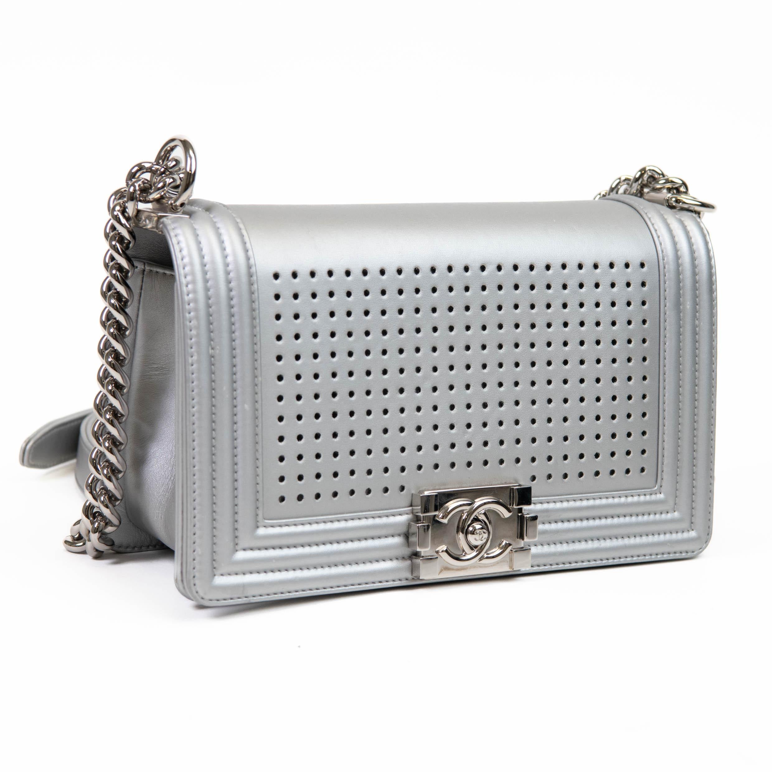 100% Authentic 

 This amazing flap bag is crafted of silver lambskin leather with linear quilted trim and a perforated front panel, showcasing a spectacular, eye-catching multicolor LED light show that has 24 different Chanel logo patterns to