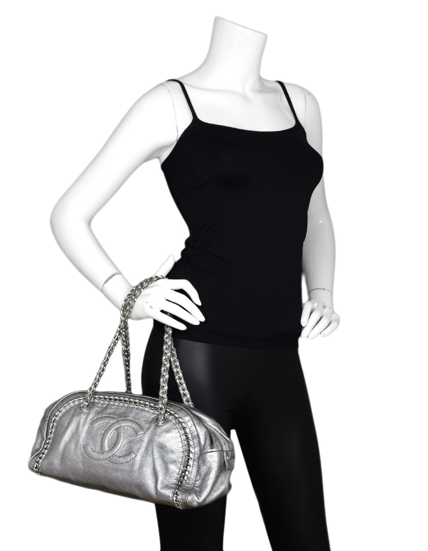 Chanel Silver Metallic Goatskin Medium Luxe Ligne CC Bowler Shoulder Bag 

Made In: France
Year of Production: 2006-2008
Color: Silver metallic 
Hardware: Silvertone
Materials: Goatskin Leather
Lining: Beige leather 
Closure/Opening: Zip top