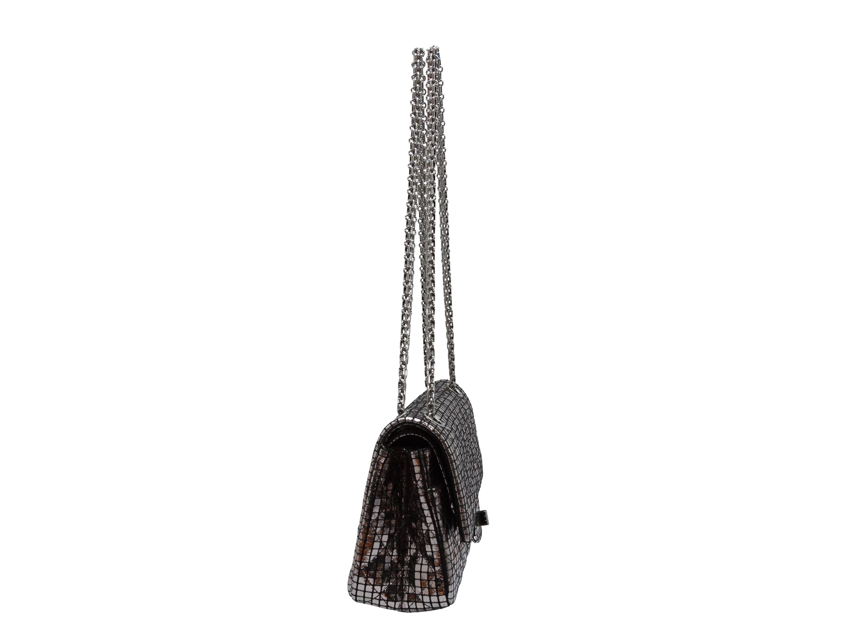 Product details: Silver mirror Reissue 225 quilted bag by Chanel. From the Fall/Winter 2012 Collection. Chain strap. Clasp closure at front clasp. 9.25