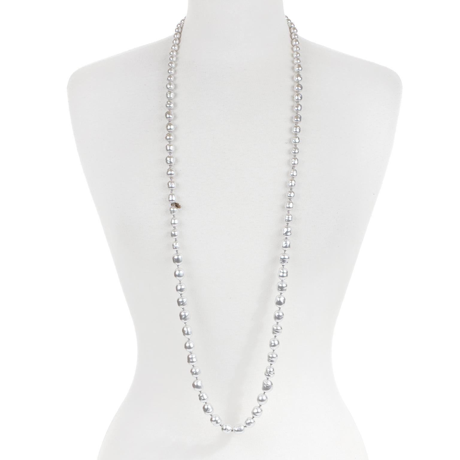 This authentic Chanel Silver Pearl Long Necklace is in excellent vintage condition from the 1981 collection.  Silver faux pearls are knotted together in a long silhouette.  May be worn single or double.  Pouch or box included.
Measurements: 42”
