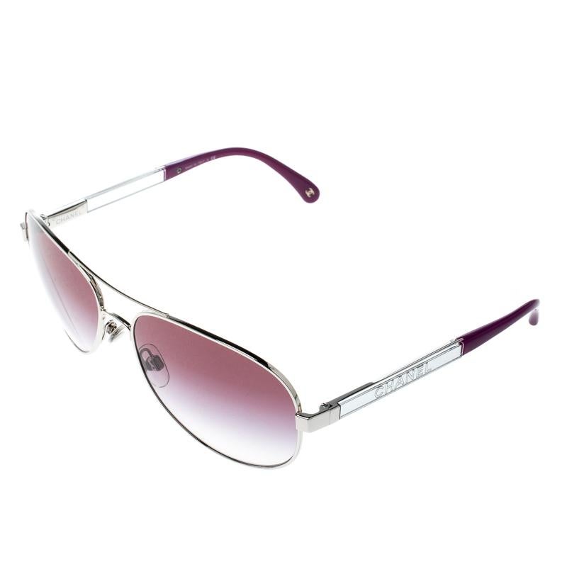 Styled to eloquently express your personal style, these Chanel sunglasses come in a silver metal frame with the brand name detailed on the temples. While its design will make you stand out, the purple lenses will provide sufficient