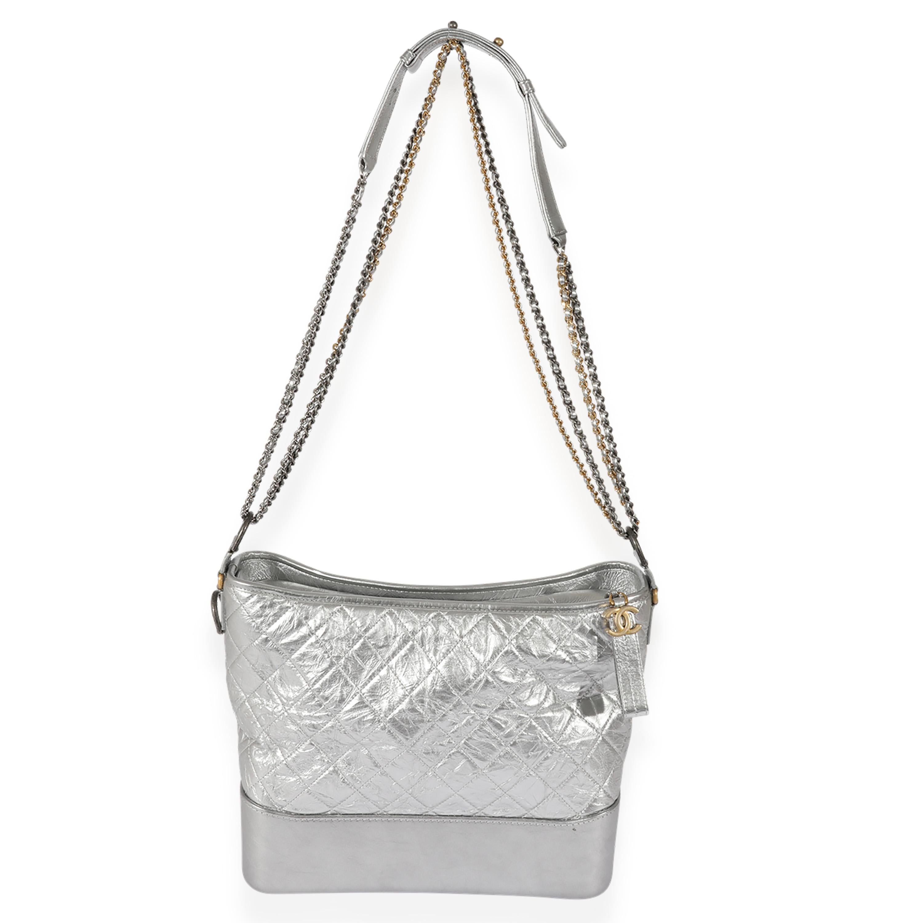 Listing Title: Chanel Silver Quilted Aged Calfskin Large Gabrielle Hobo
SKU: 126527
Condition: Pre-owned 
Handbag Condition: Very Good
Condition Comments: Very Good Condition. Scuffing at exterior and marks throughout. Light scratching at