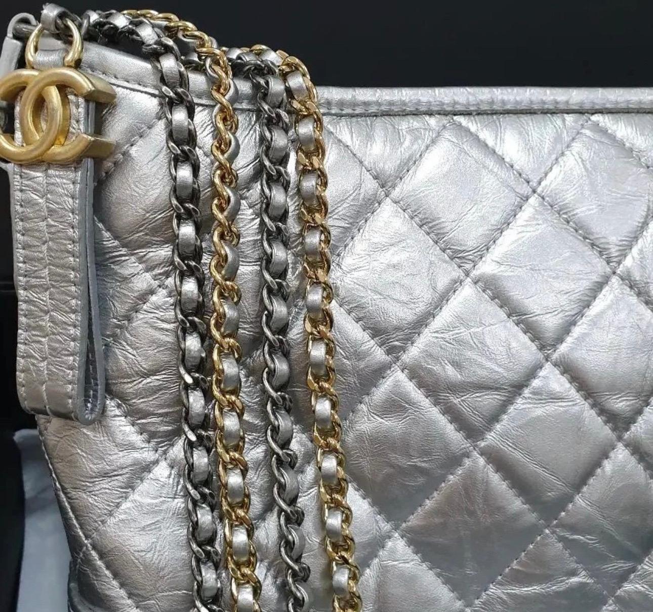 From the Spring 2017 collection, this current Gabrielle Hobo Bag is part of Chanel's new 'Gabrielle' line. 
This particular hobo bag features a sturdy base that provides structure for the quilted leather sides. 
The bag comes with a unique chain