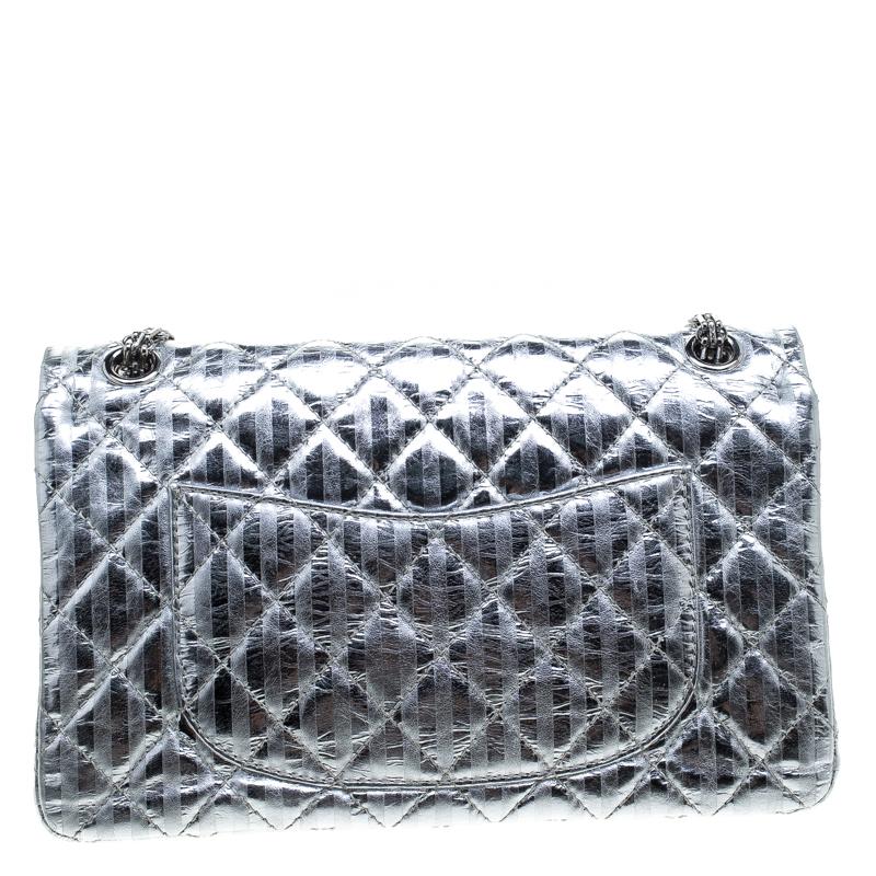 Chanel's Flap Bags are iconic and monumental in the history of fashion. Hence, this Reissue 2.55 Classic 226 is a buy that is worth every bit of your splurge. Exquisitely crafted from silver leather, it bears their signature quilt pattern and the
