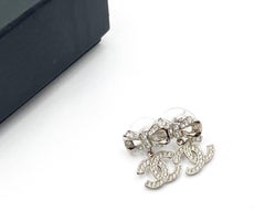 Chanel Silver Ribbon CC Dangle Crystal Piercing Earrings