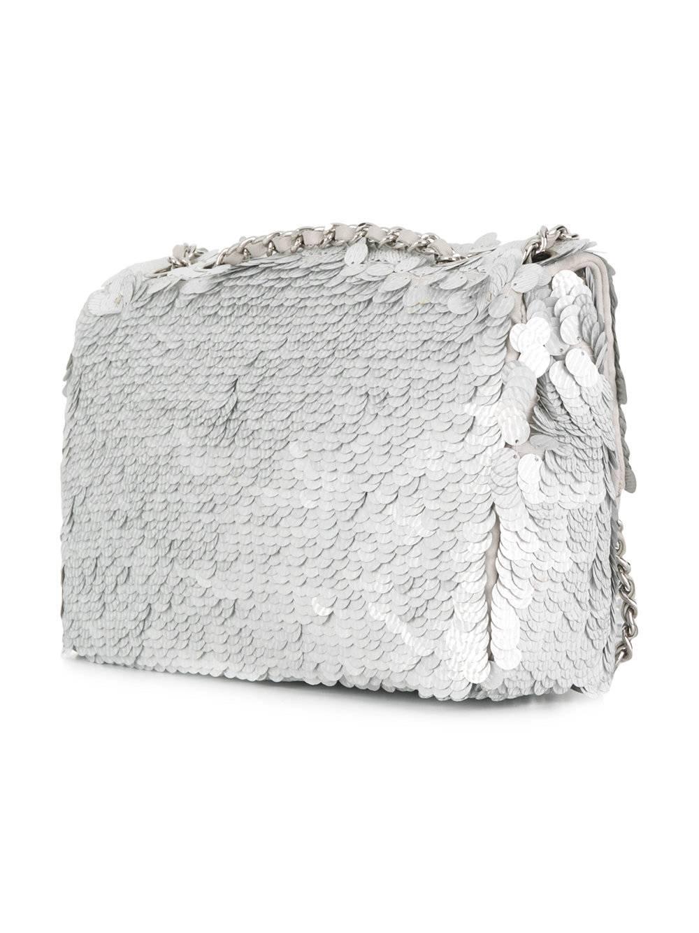 This silver sequin logo shoulder flap bag from Chanel featuring an open top design, a chain shoulder strap, an internal zipped pocket and an internal logo patch.

This bag comes with its original Chanel box, dust bag, certificate of authenticity and