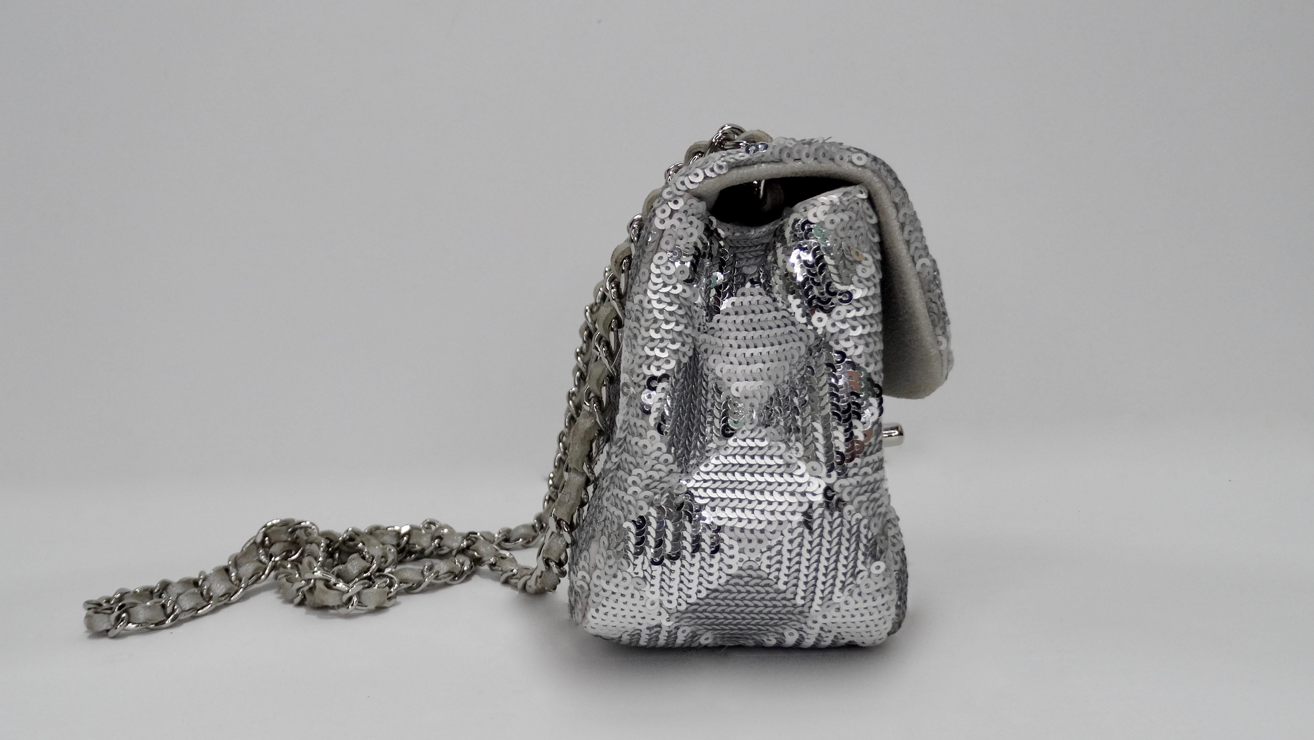 All eyes on you with this amazing mini Chanel! Circa 2014, this adorable mini single flap bag features a geometric pattern crafted out of matte/metallic silver sequins, silver hardware, and a silver metallic leather and chain link strap. Exterior CC