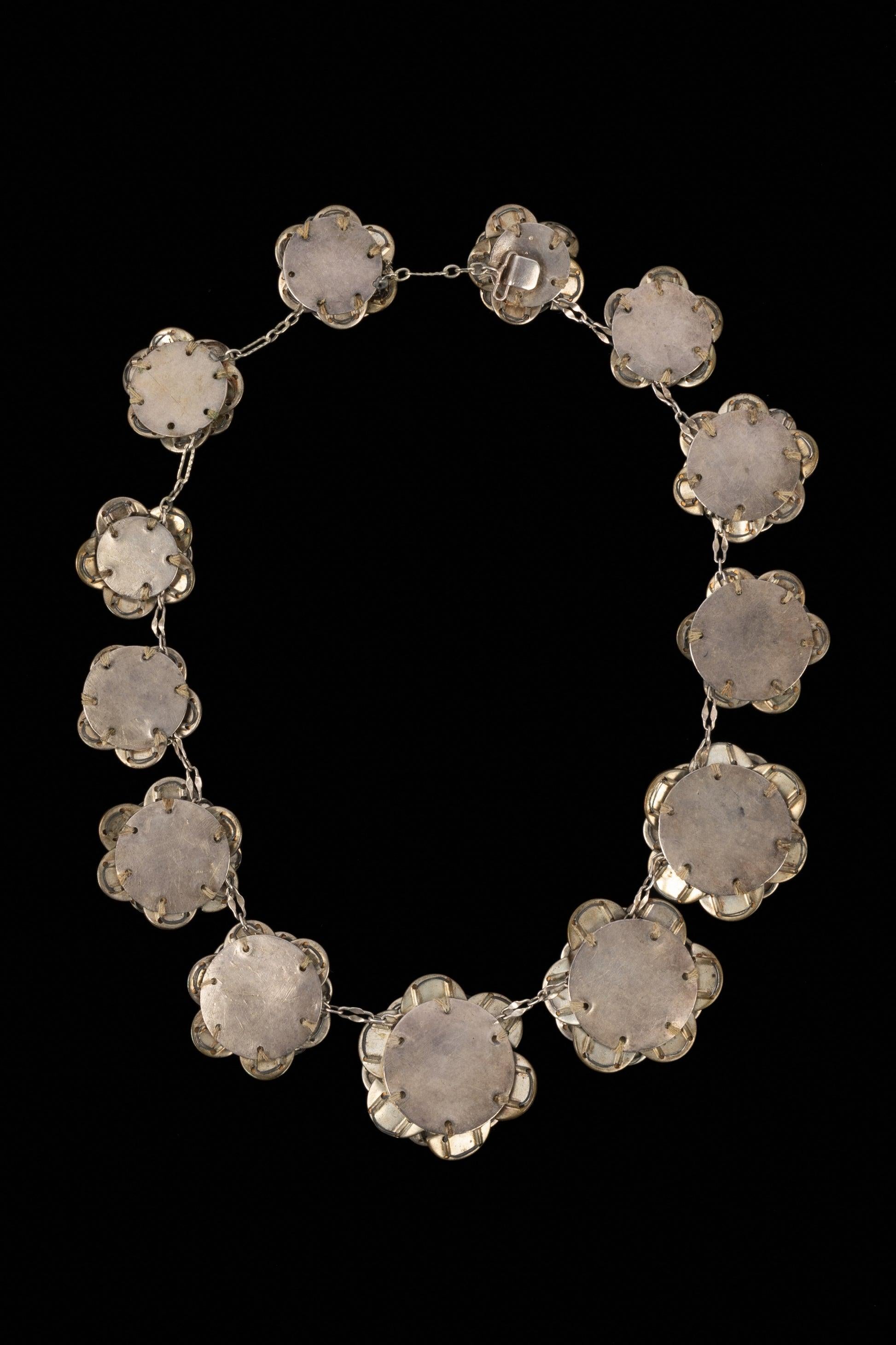 Chanel - Necklace composed of rhinestone semicircles assembled in a rose shape on silvery metal circles, the whole following an 