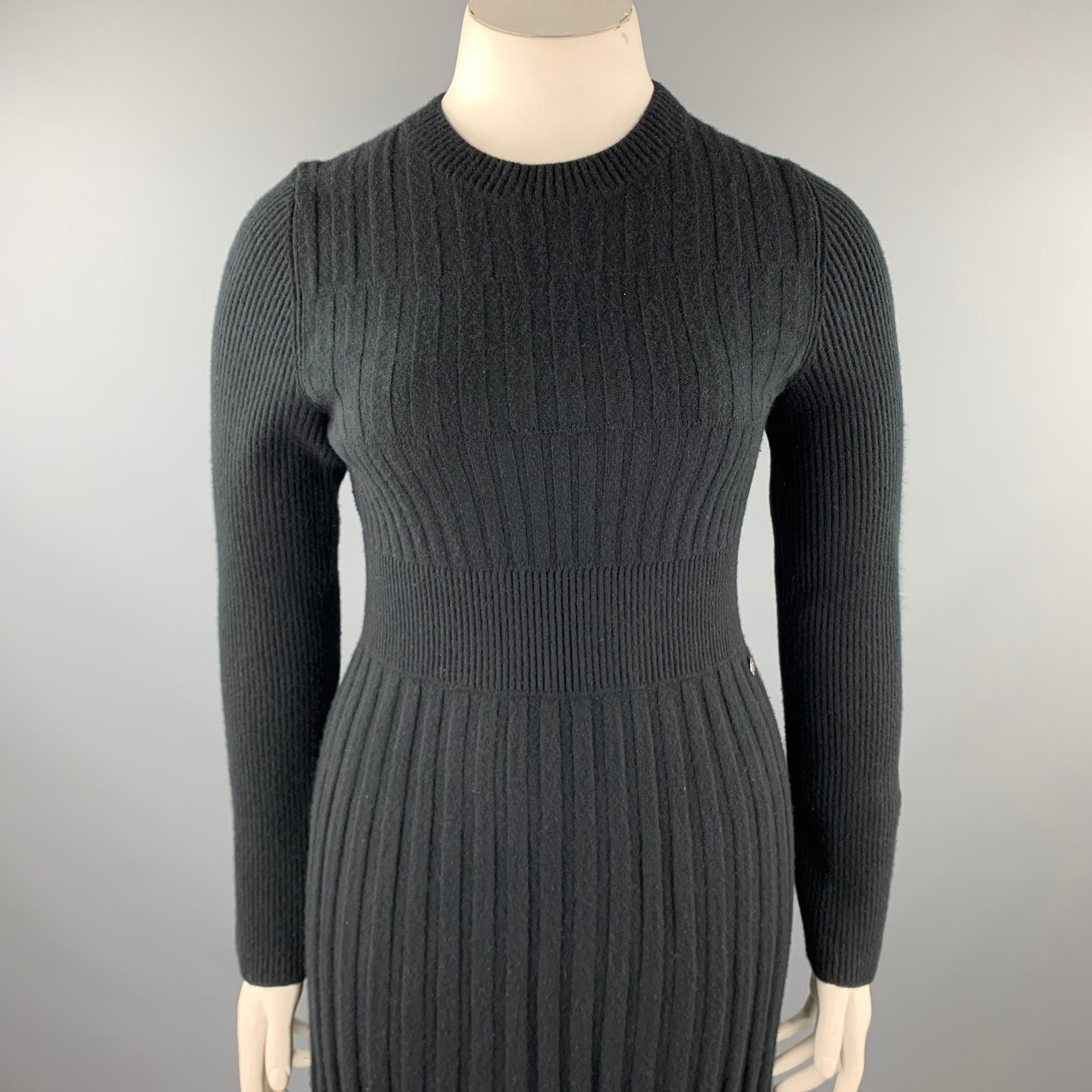 CHANEL sweater dress comes in a black knitted pleated wool featuring an a-line style, long sleeves, and a crew-neck. Made in Italy.

Very Good Pre-Owned Condition.
Marked: FR 42
Original Retail Price: $5,640.00

Measurements:
 
Shoulder: 16.5 in.