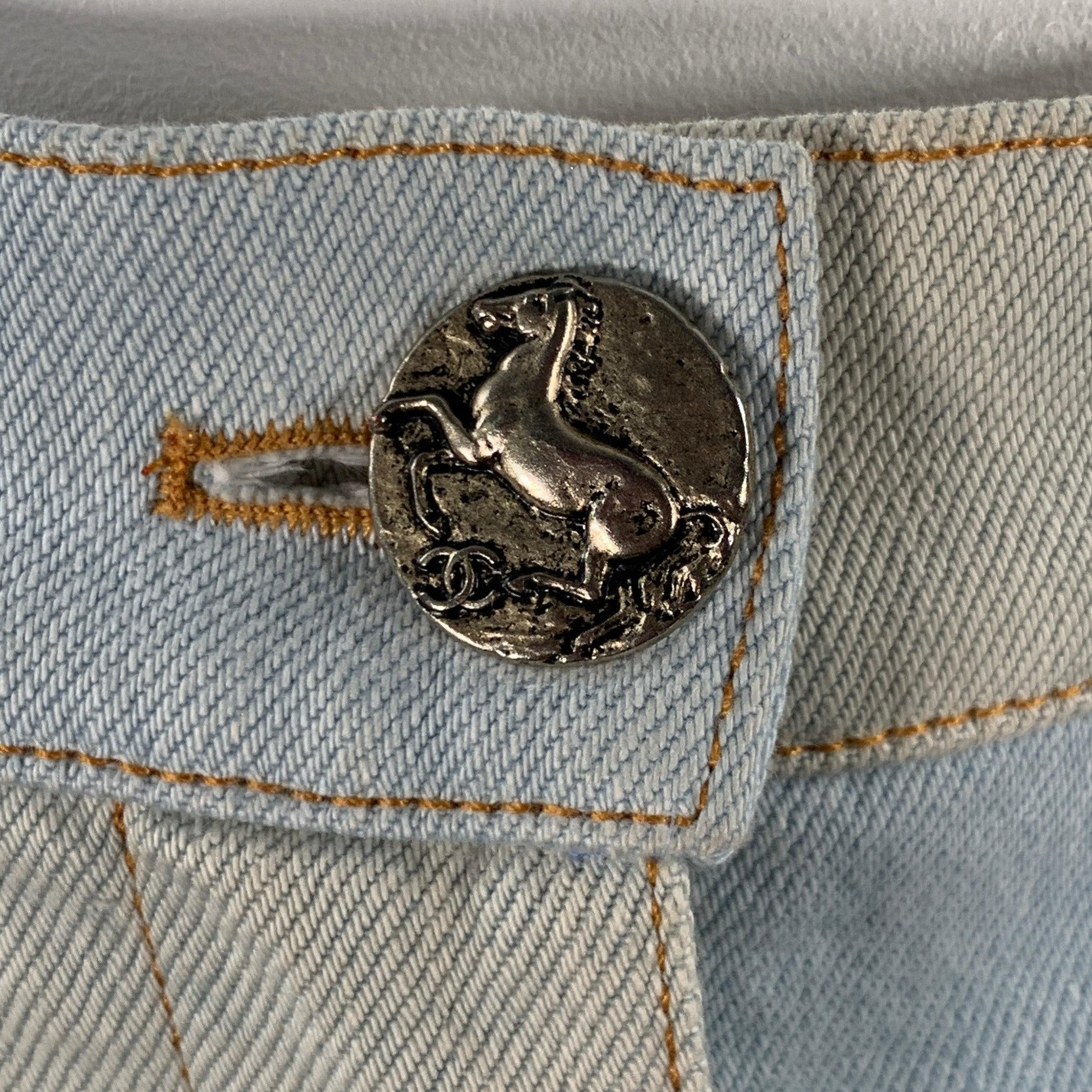 CHANEL casual pants
in a blue and grey cotton woven denim twill featuring an extra wide leg style, button up leg details with silver tone metal equestrian buttons with CC monogram, and zip fly closure. Made in Italy.Excellent Pre-Owned Condition.
