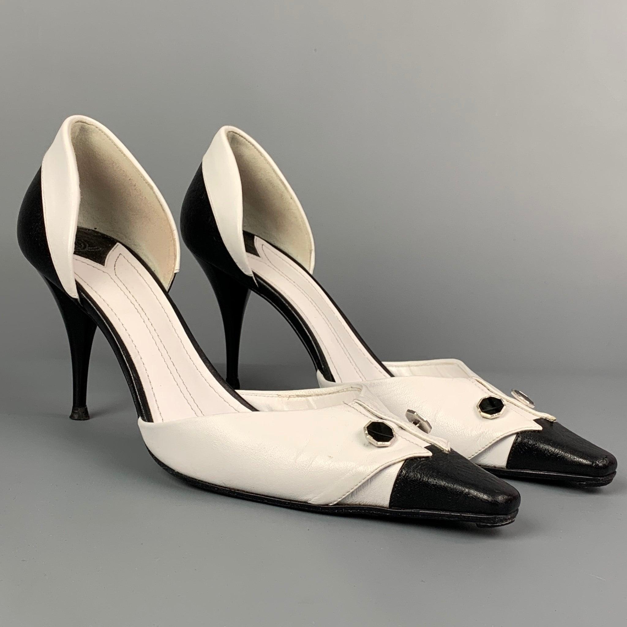 CHANEL pumps comes in a white & black two toned leather featuring a D'Orsay style, folded flap, silver button details, and a stiletto heel. Made in Italy.Very Good Pre-Owned Condition. 

Marked:   EU 40 

Measurements: 
  Heel: 3.5 inches 
  
  
