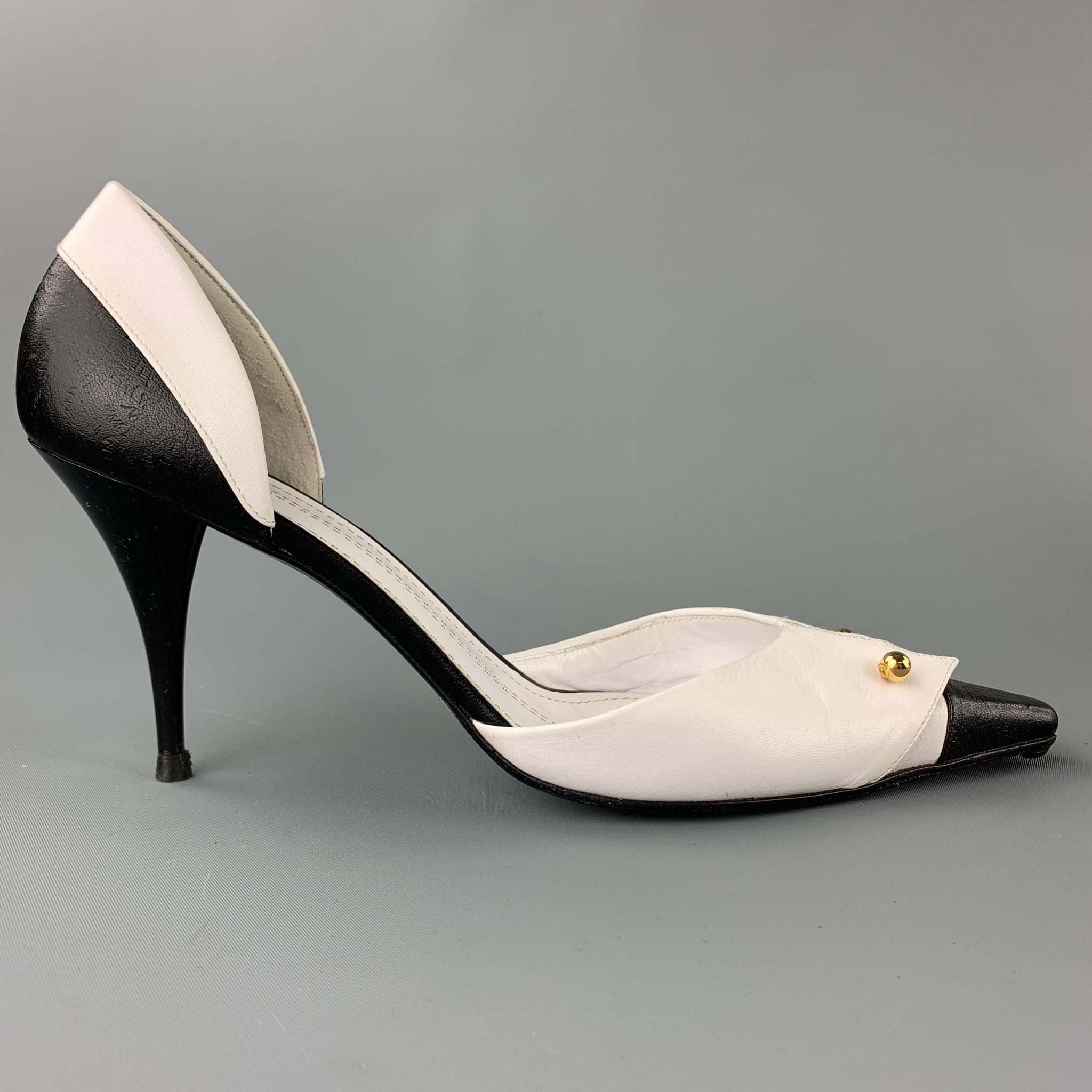 CHANEL pumps comes in a white & black two toned leather featuring a D'Orsay style, folded flap, gold tone logo bar detail, and a stiletto heel. Made in Italy.

Very Good Pre-Owned Condition.
Marked: EU 40

Measurements:

Heel: 3.5 in.