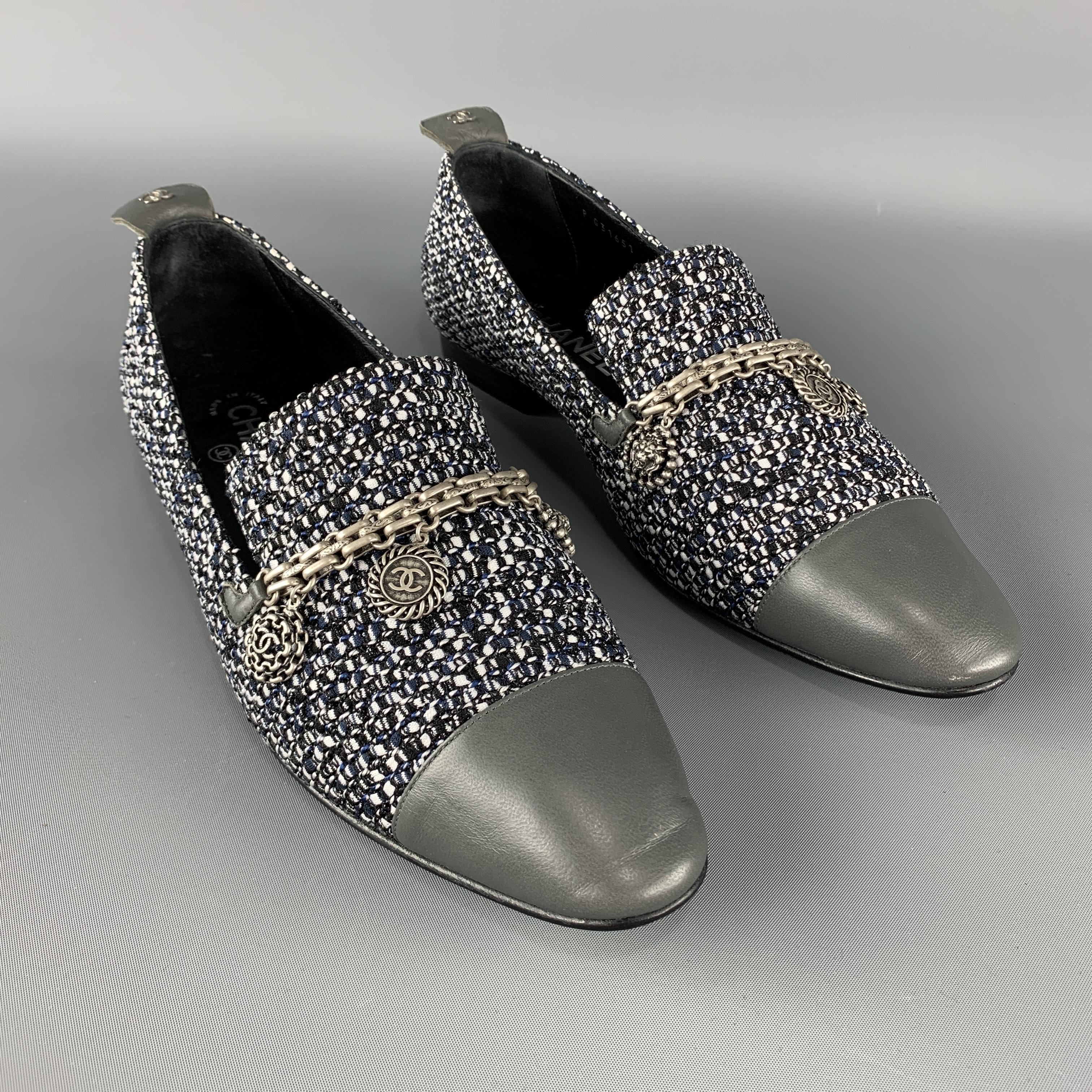 CHANEL Loafer Flats comes in grey tones in a tweed material, with silver metal tone charms and a cap toe. Made in Italy.
 
Excellent Pre-Owned Condition.
Marked: IT 40 1/2    P G31651
 
Outsole: 11 x 3.5 in