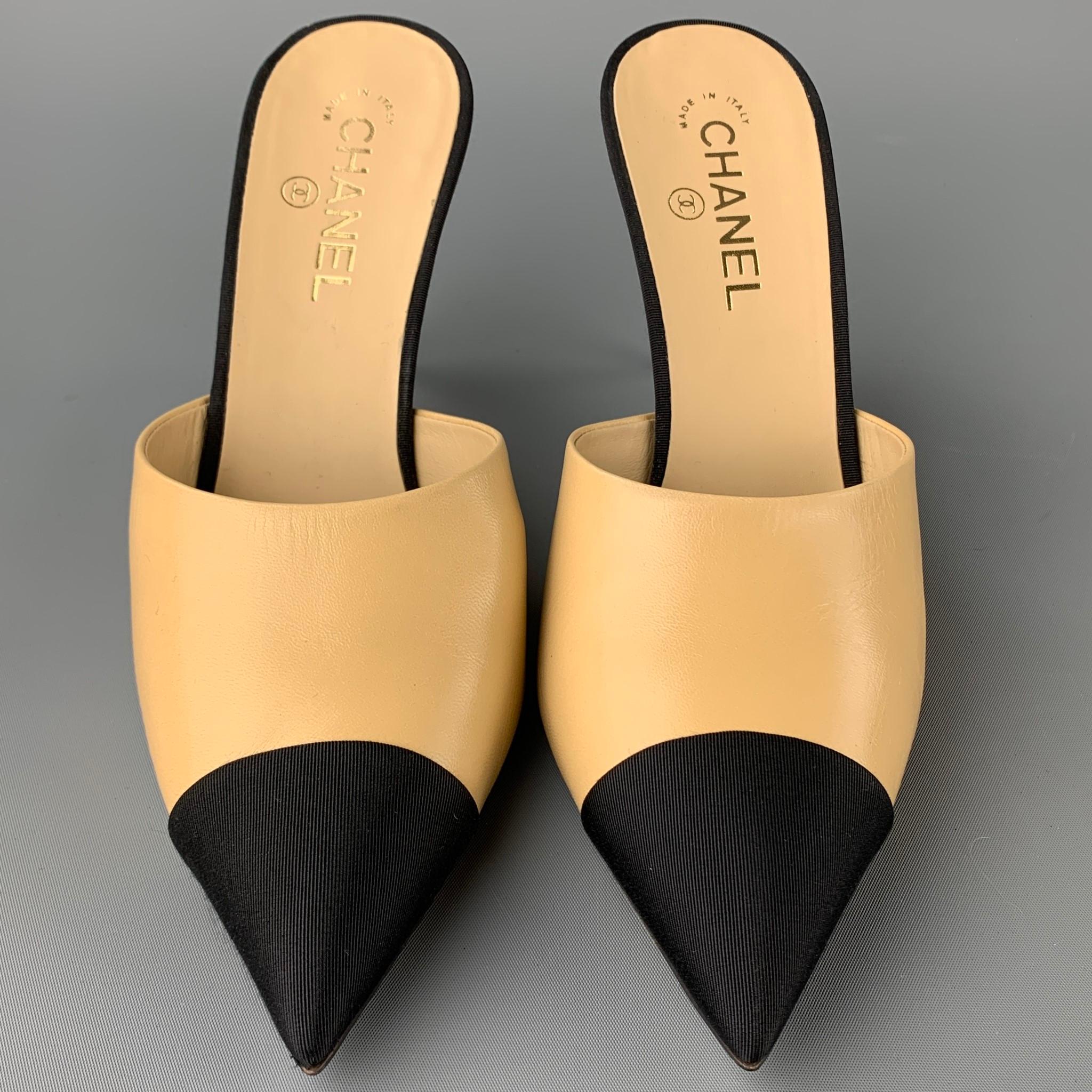 CHANEL pumps comes in a beige leather with a black grosgrain trim featuring a mule style, pointed toe, and a pearl CC design. Made in Italy.

Excellent Pre-Owned Condition.
Marked: EU 41

Measurements:

Heel: 4 in.